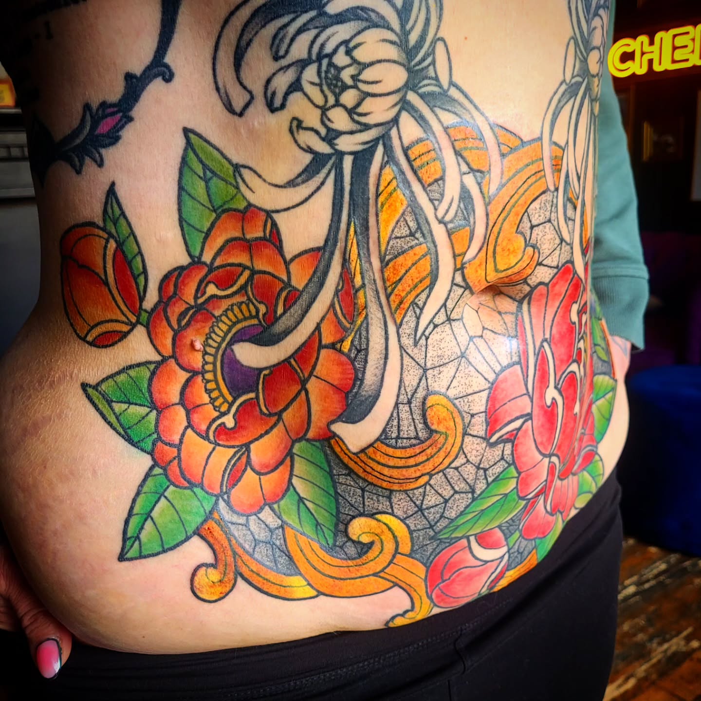 Floral and oriental American traditional tattoo on the torso by Ashley Thomas, Midvale, Utah