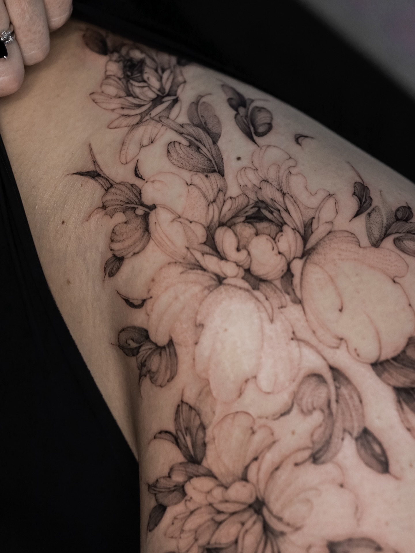 Floral bouquet black and grey tattoo on the forearm by Maria