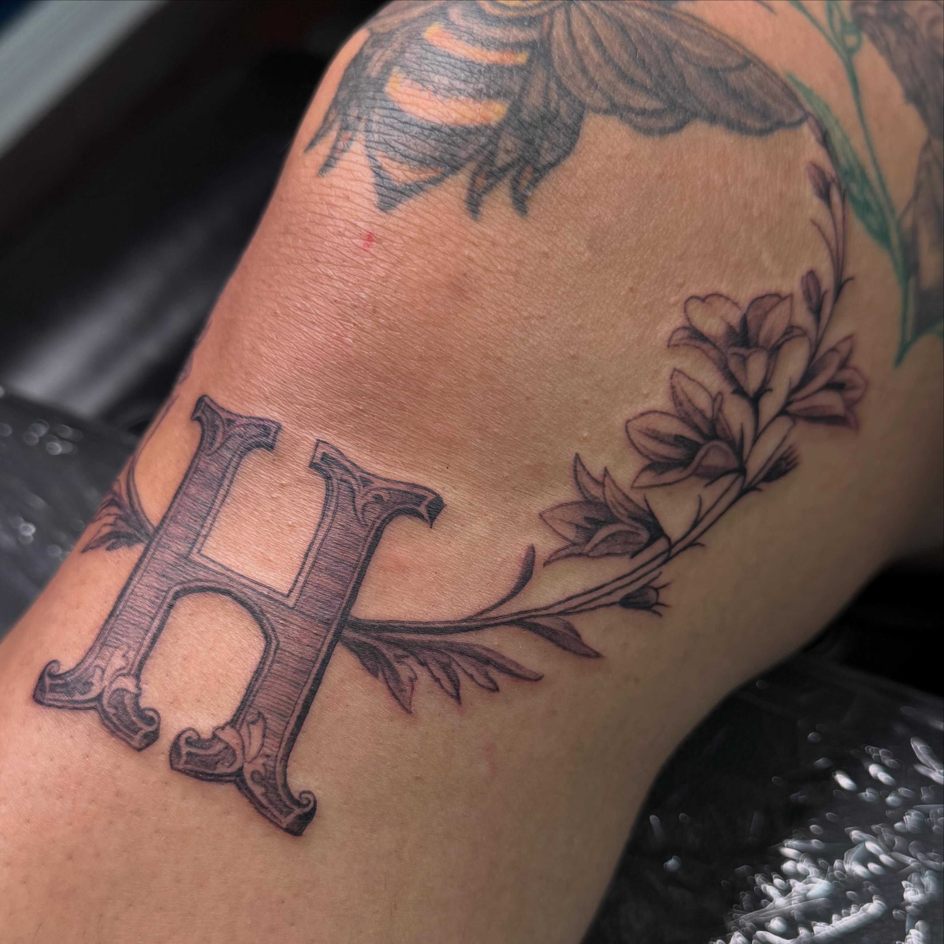 Letter H black and grey tattoo on the forearm by Angie Morales, Laredo, Texas