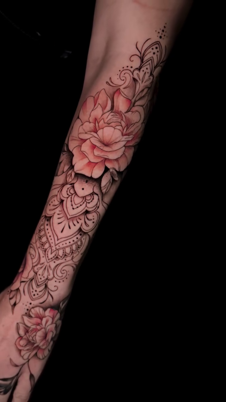 Floral and mandala sleeve dotwork tattoo on the upper arm by Jennifer Ramirez