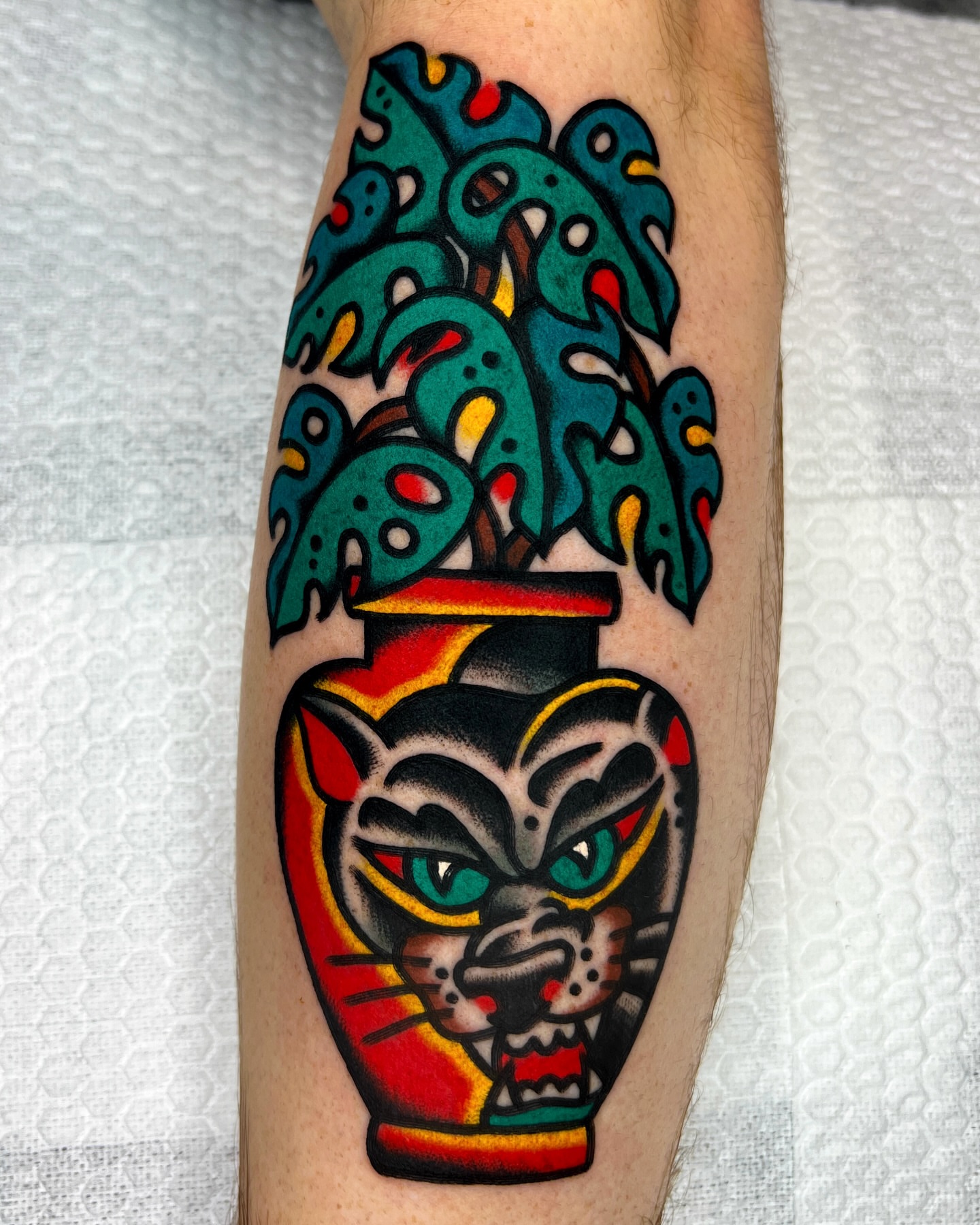 Tiger head with plant American traditional tattoo on the forearm by 올드스쿨타투 호무