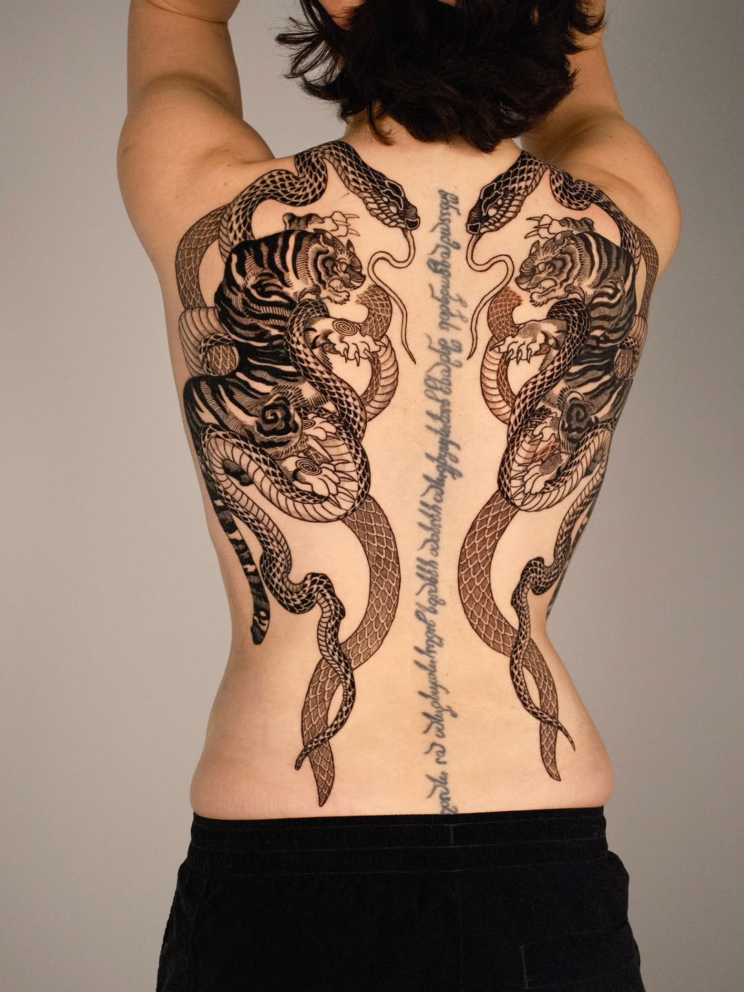 Tigers and snakes with script tribal tattoo on the back by Kubo