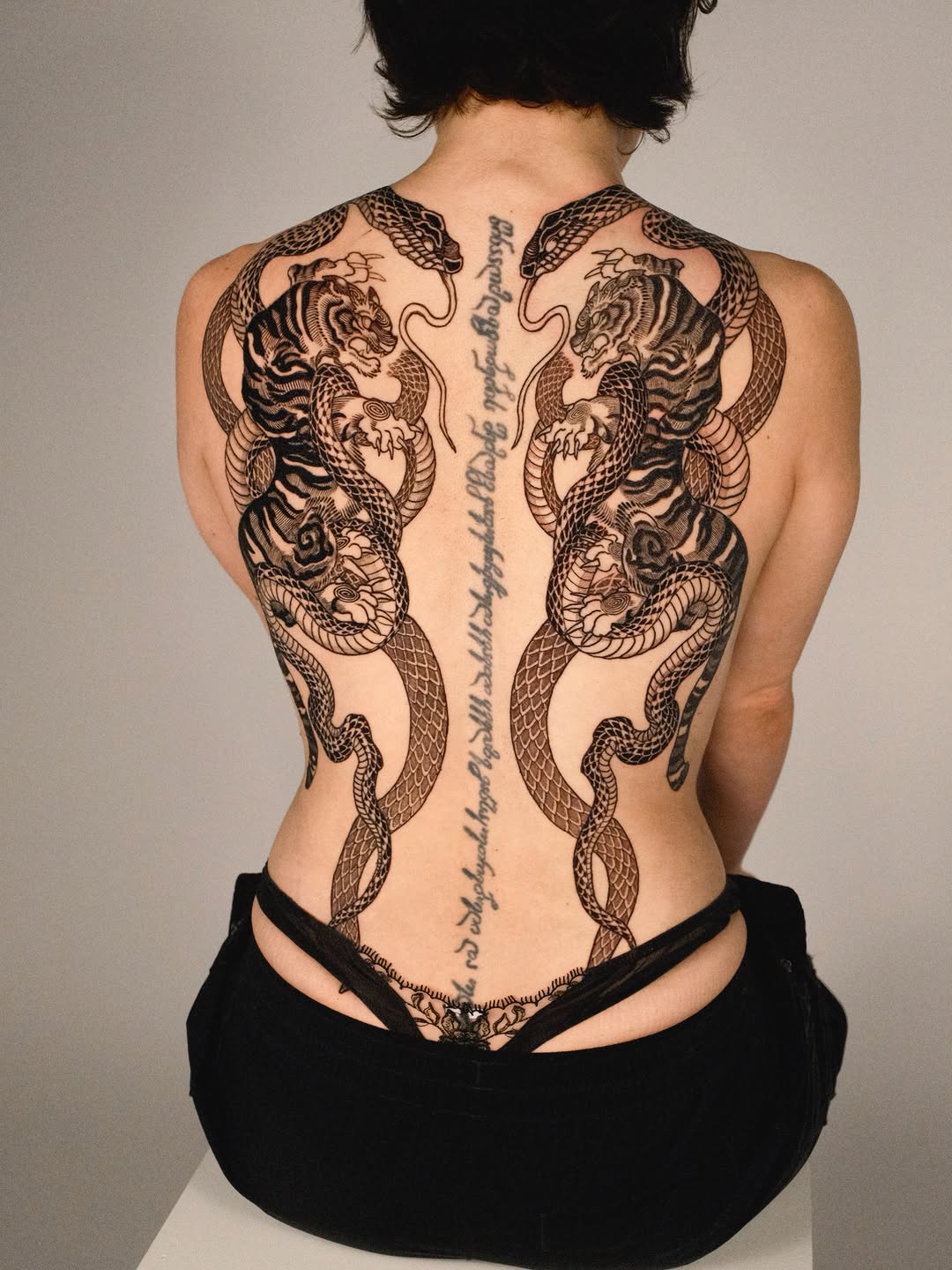 Tigers and snakes with script tribal tattoo on the back by Kubo