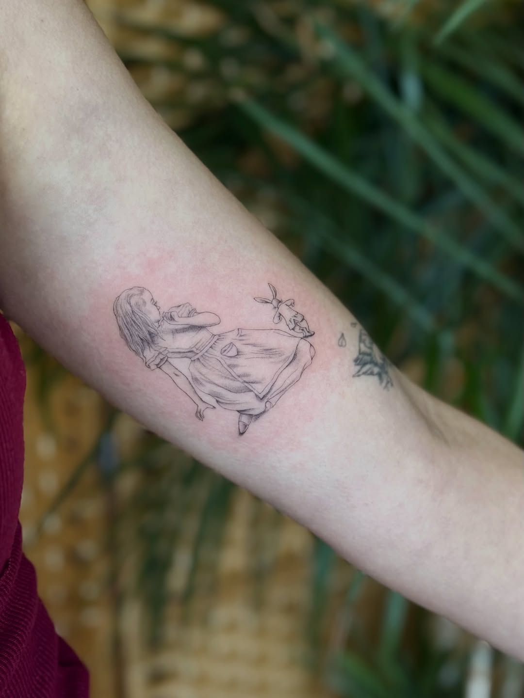 Girl and rabbit minimalist tattoo on the forearm by Fabian💉 Tattoo artist