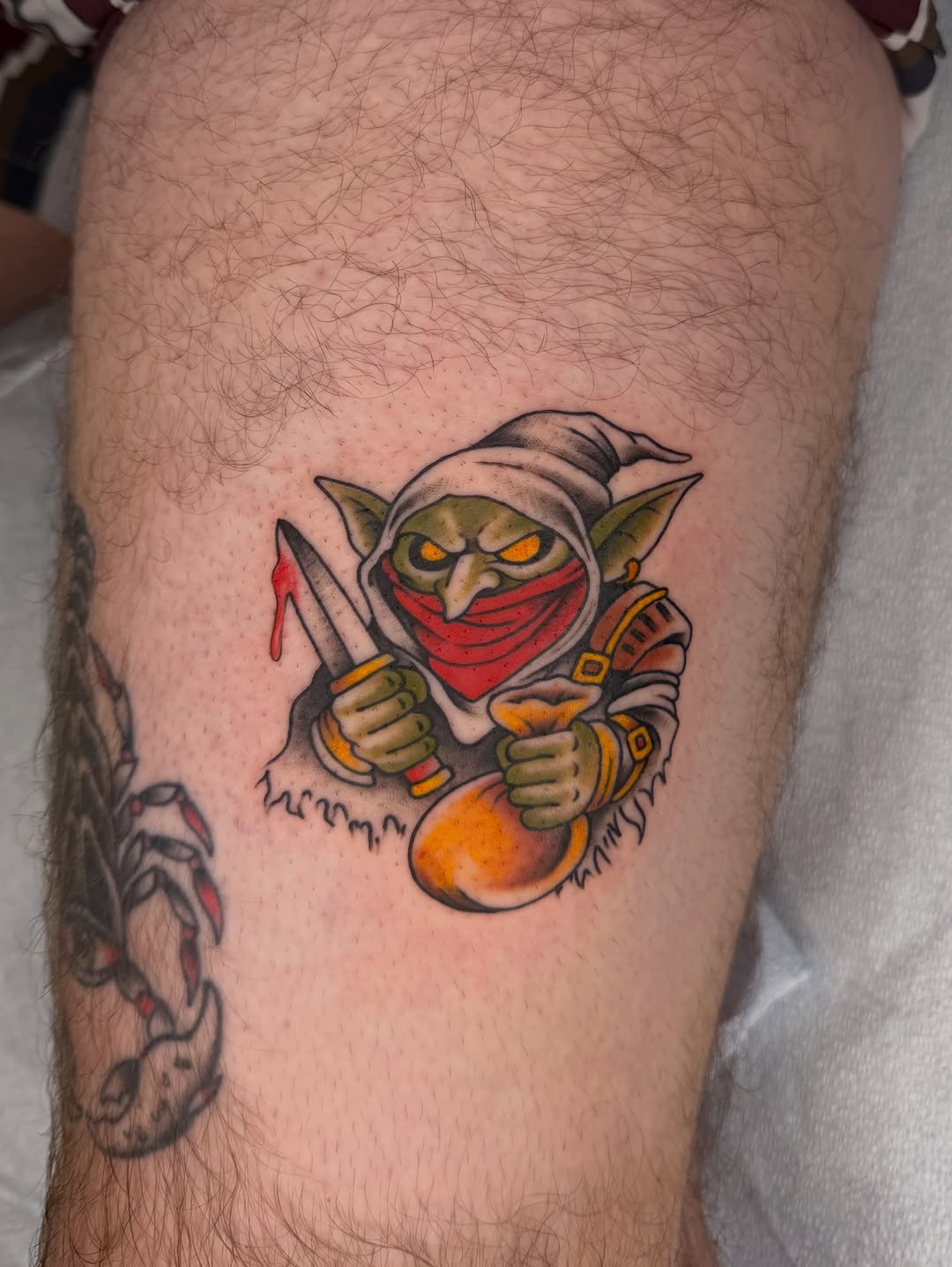 Goblin with knife and money bag American traditional tattoo on the thigh by Fabian💉 Tattoo artist