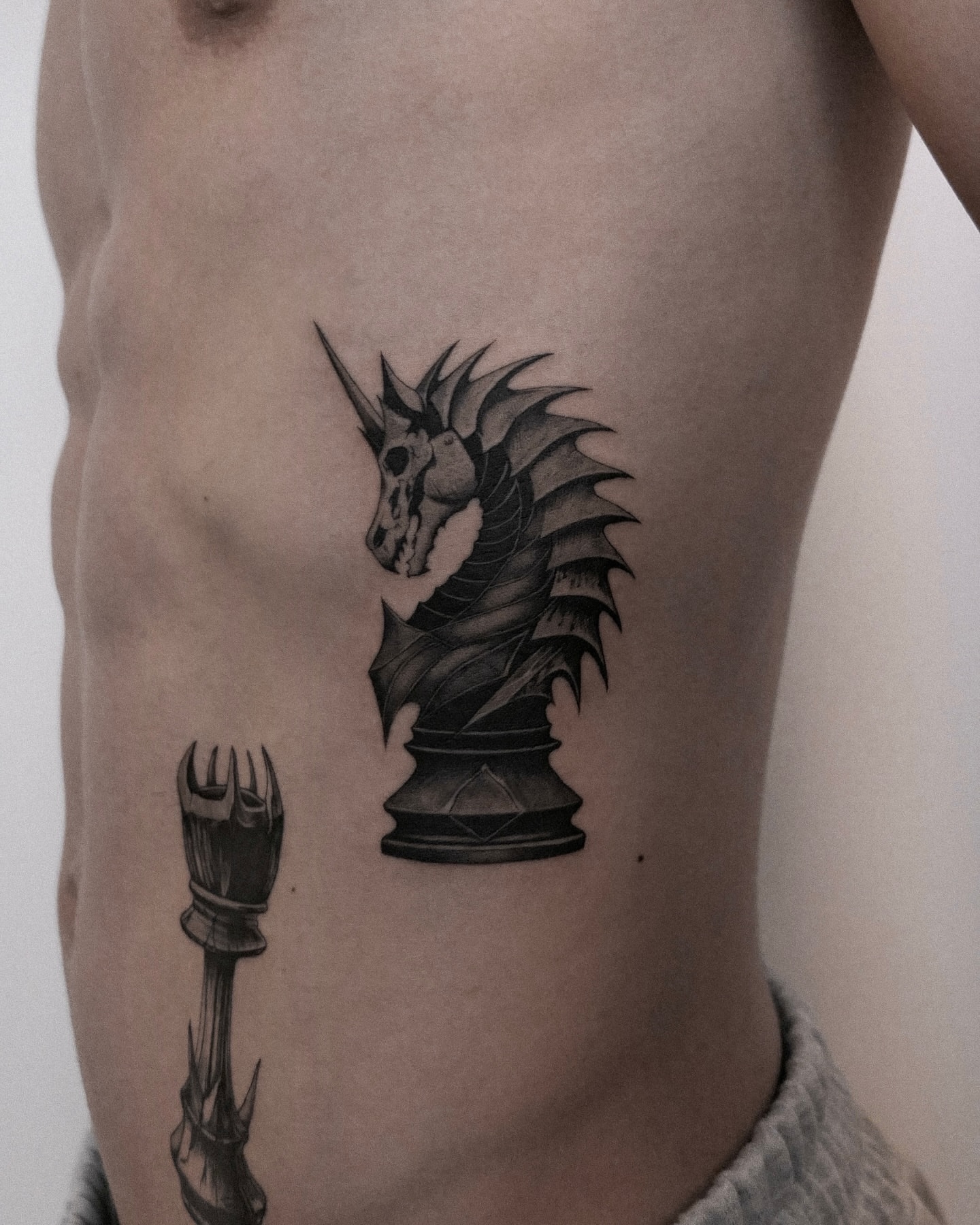 Dragon chess piece realism tattoo on the ribs by 𝑴𝒆𝒍𝒐