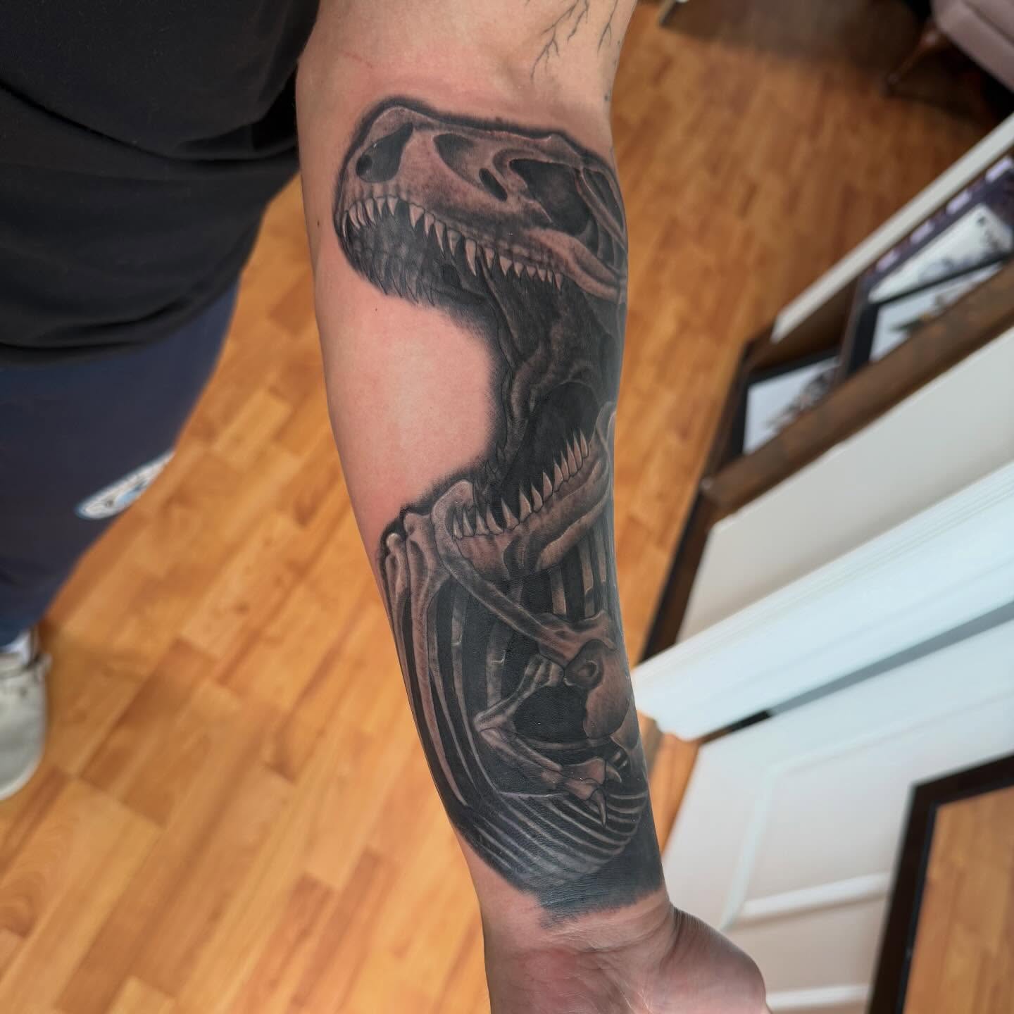 Dinosaur skeleton realism tattoo on the forearm by Matt Hattaway