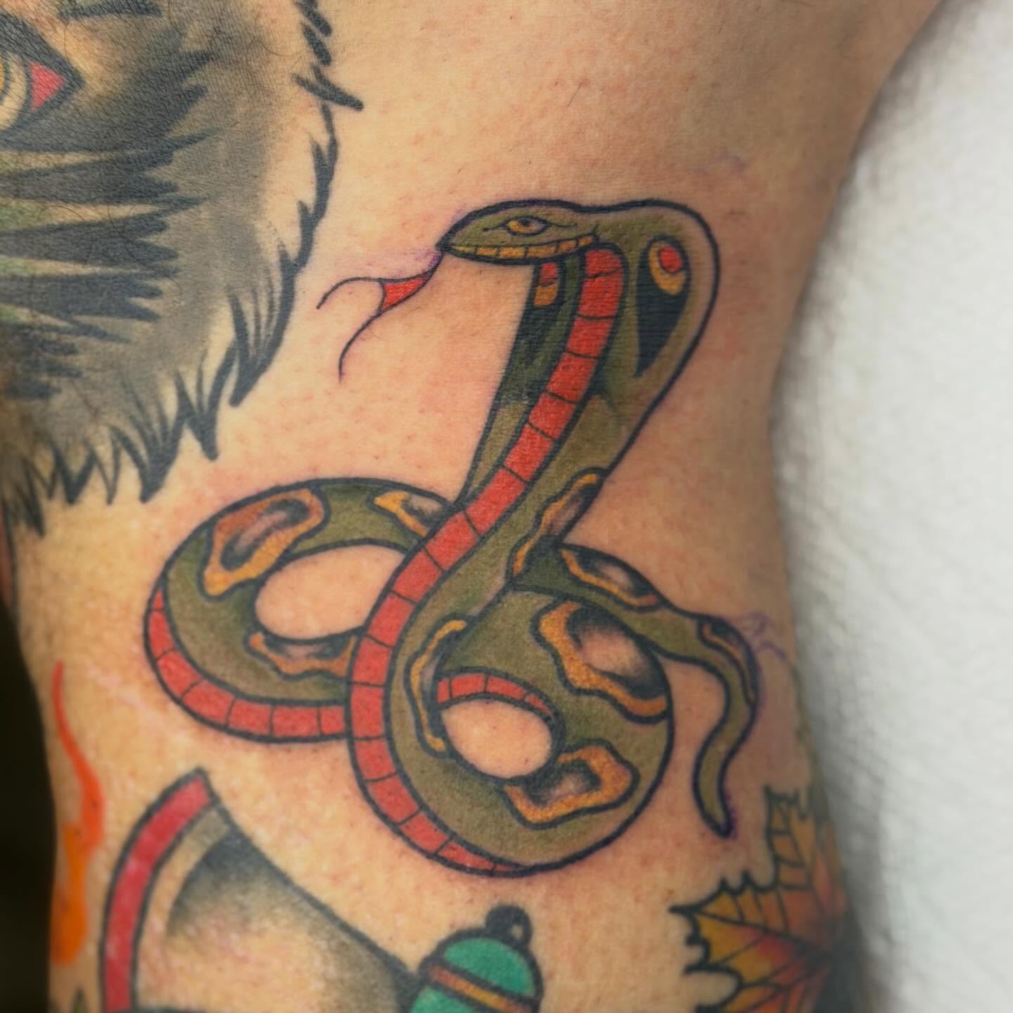 Snake American traditional tattoo on the forearm by Jenna Szerszen-Wynn ๐