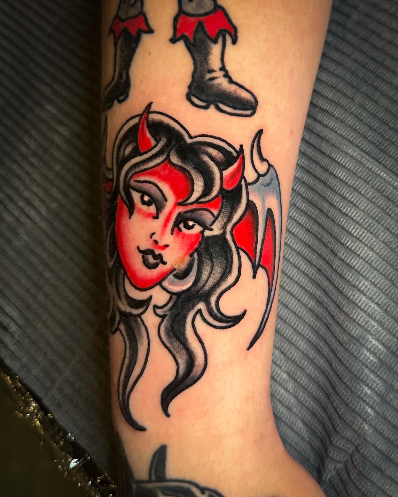 Devil woman American traditional tattoo on the forearm by Stacey Colangelo