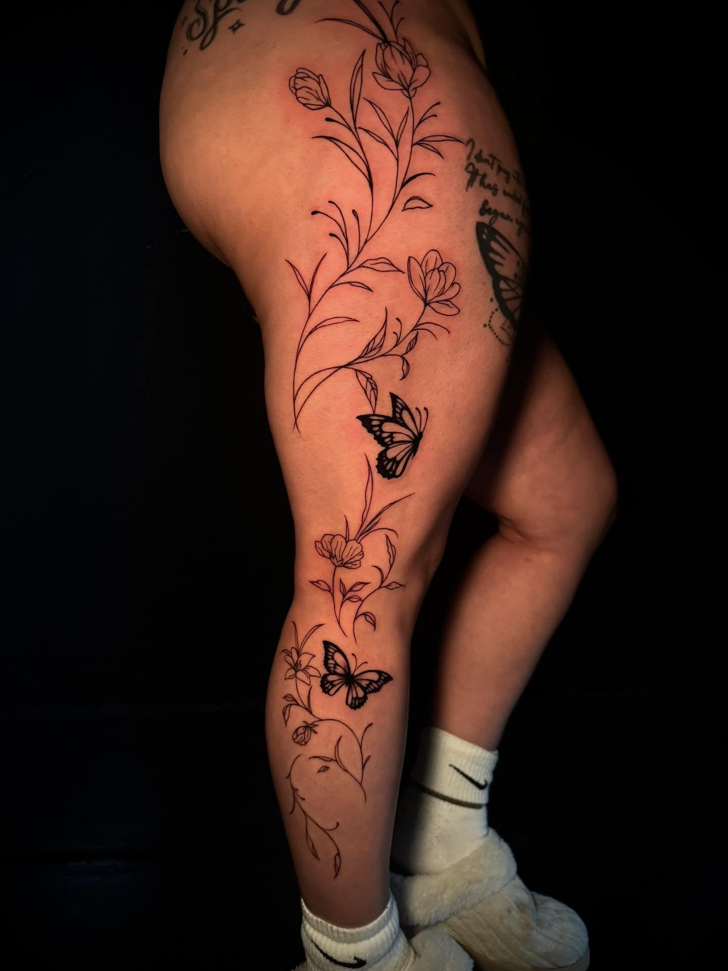 Floral and butterfly black and grey tattoo on the thigh by π΅ππππππ¦π€