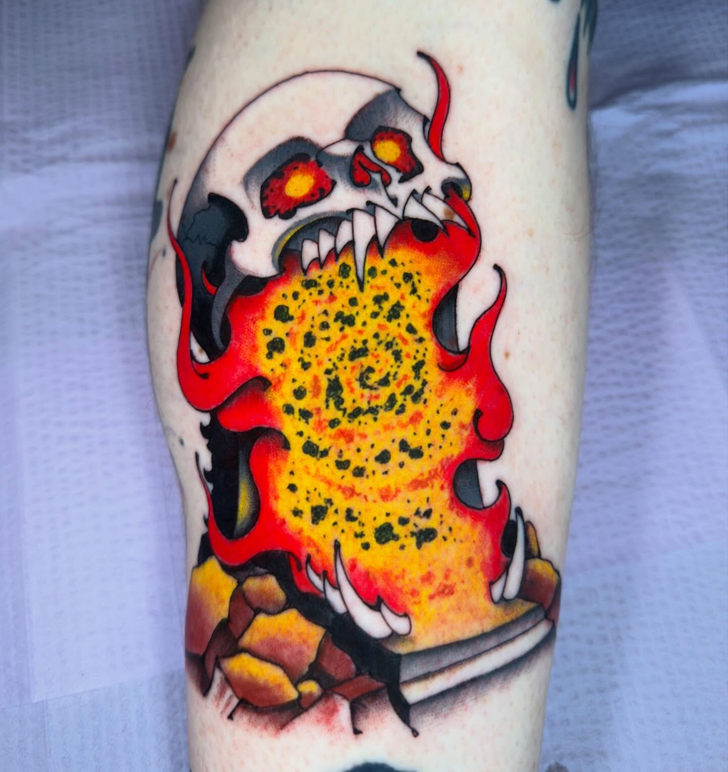 Flaming skull trash polka tattoo on the forearm by Bryan Ortega