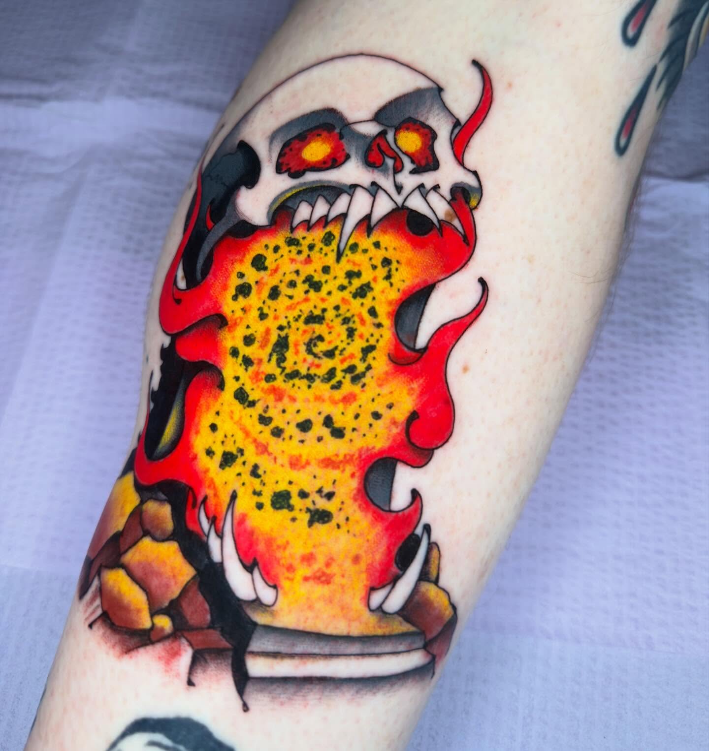 Flaming skull American traditional tattoo on the forearm by Bryan Ortega