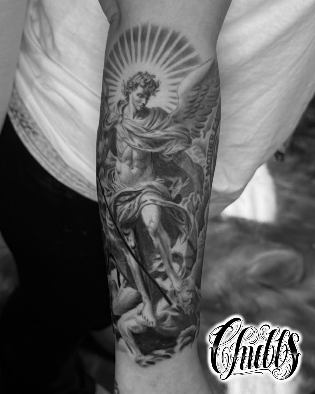 Archangel Michael slaying a demon realism tattoo on the forearm by Chubbs