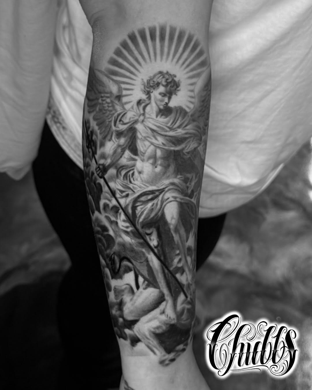 Archangel Michael slaying a demon realism tattoo on the forearm by Chubbs