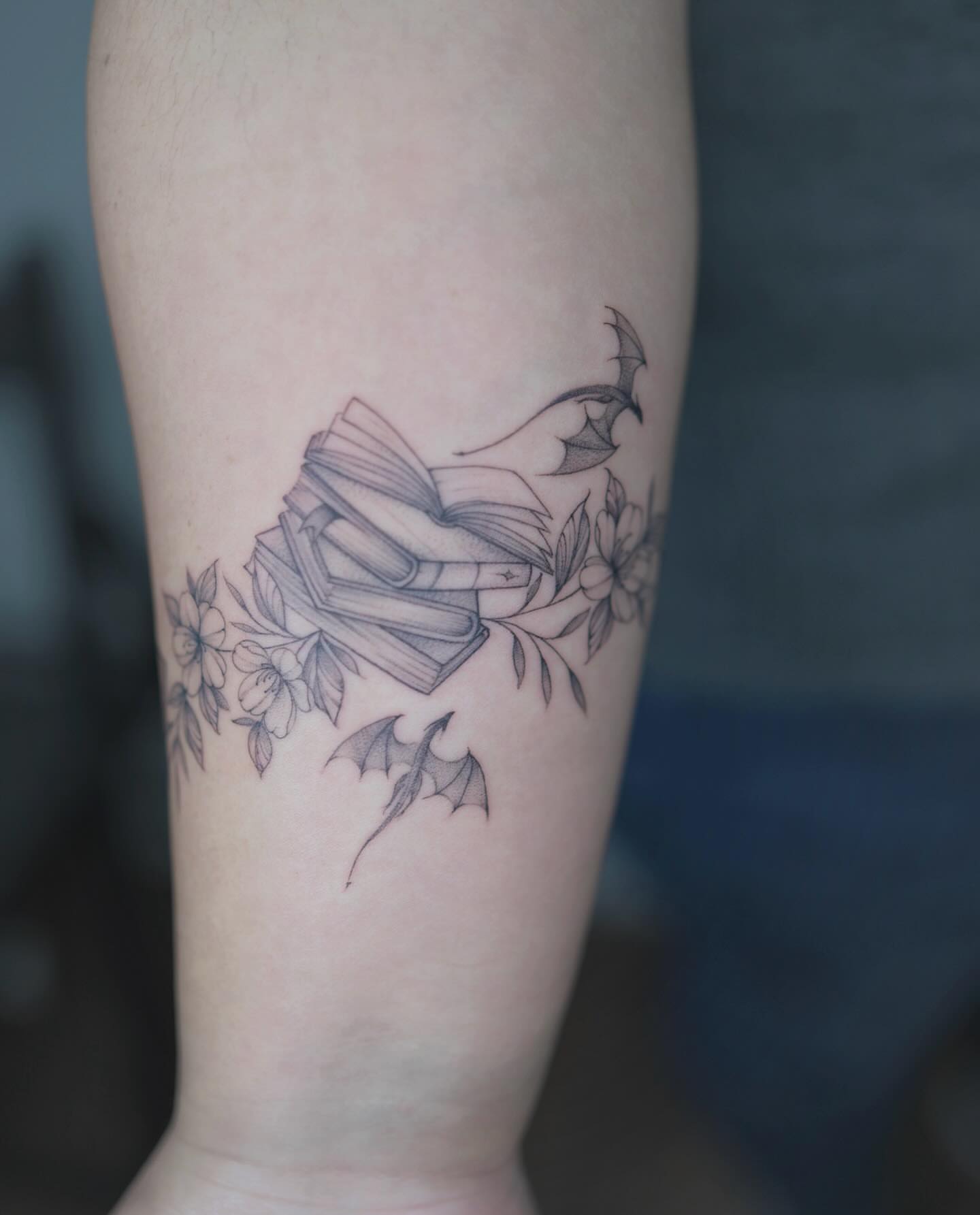 Book and bats realism tattoo on the forearm by Seattle tattoo artist-Mia