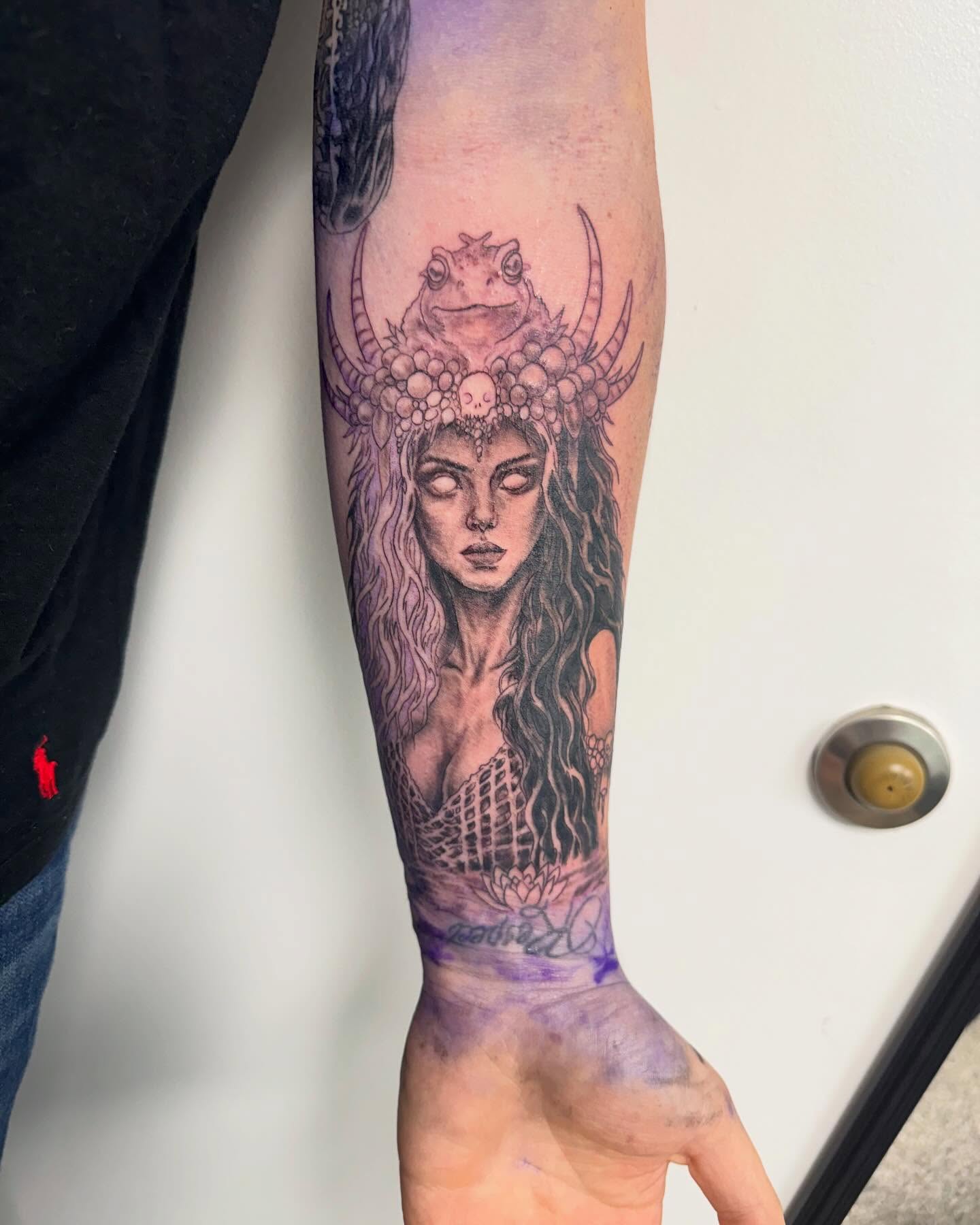 Woman with frog headdress realism tattoo on the forearm by Brazun Locker Poloschan