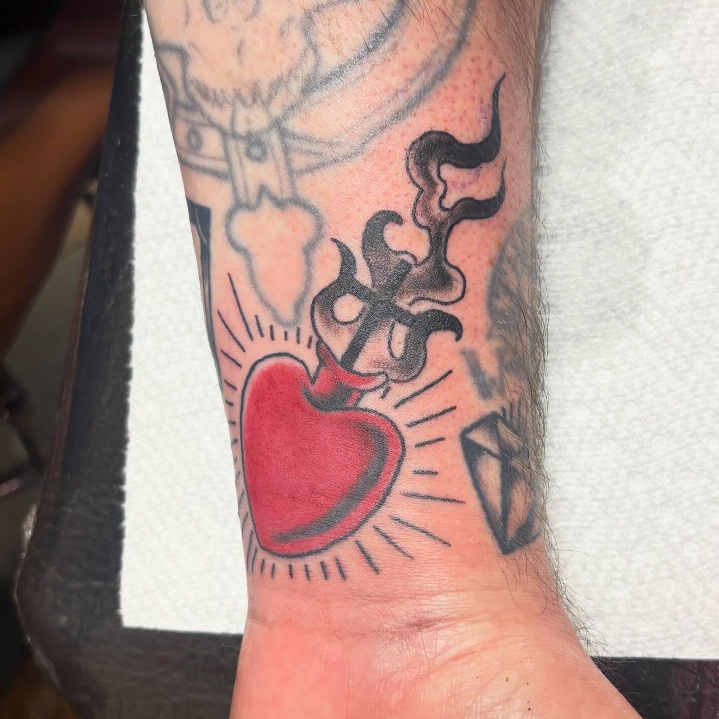 Heart with cross American traditional tattoo on the forearm by Gabby, Kansas City, Missouri