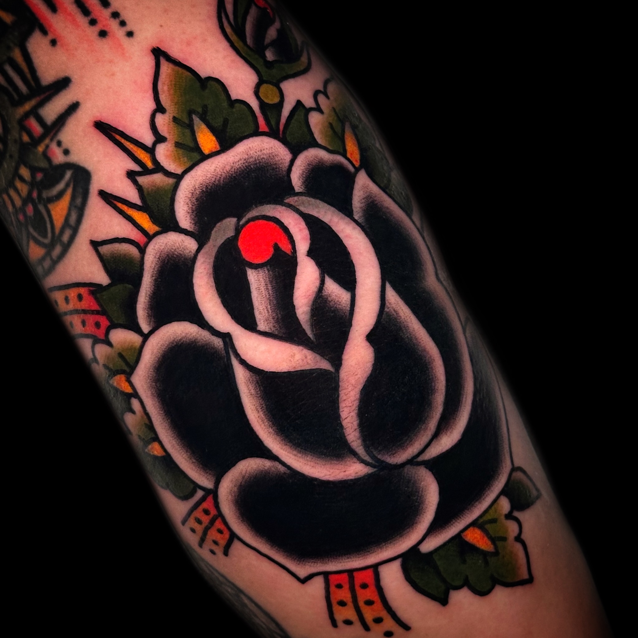Black rose American traditional tattoo on the forearm by Danny Reis
