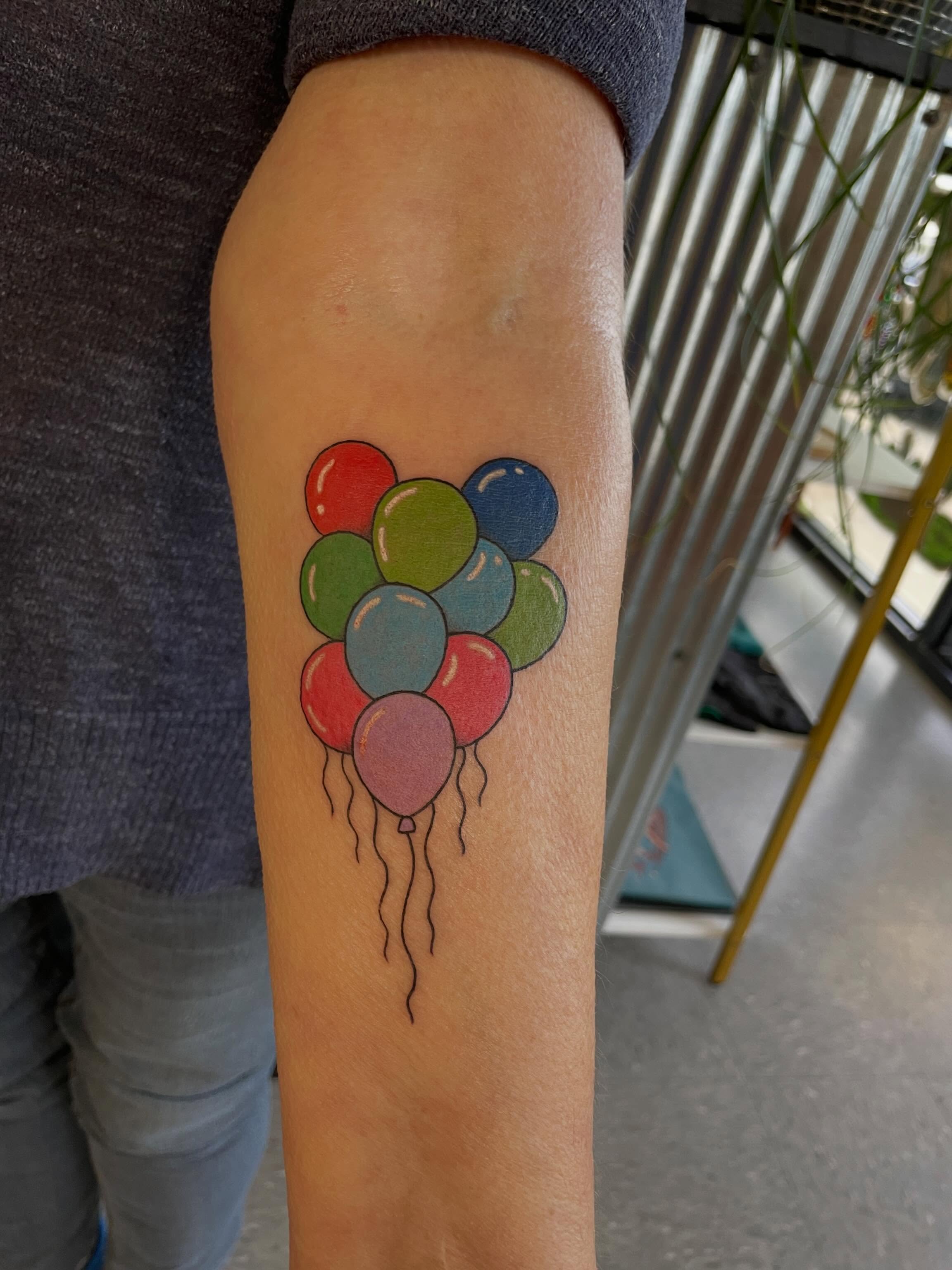 Balloons dotwork tattoo on the forearm by Mallory Moore