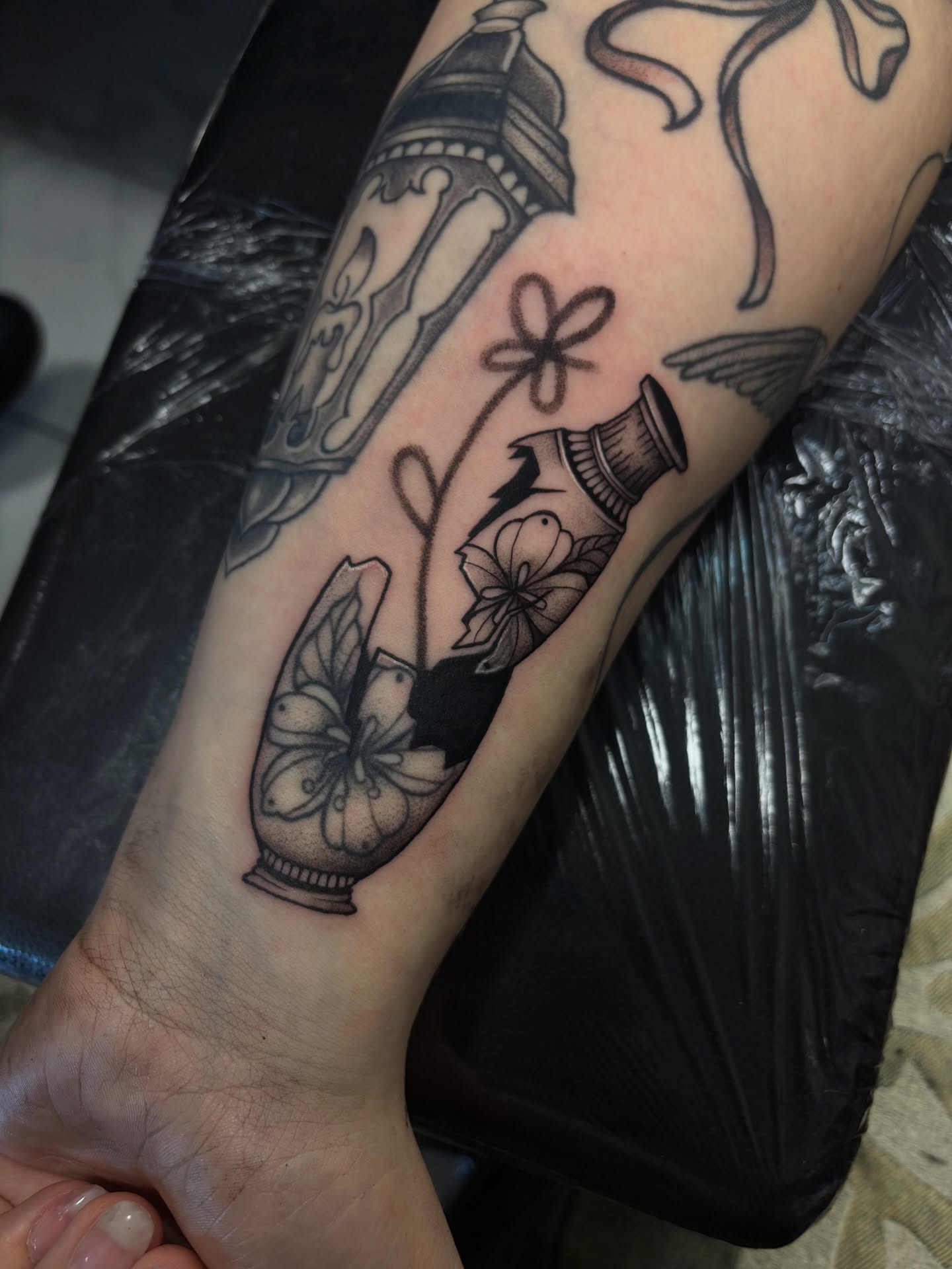 Vase and flowers black and grey tattoo on the forearm by Zilla - Tattoo Artist