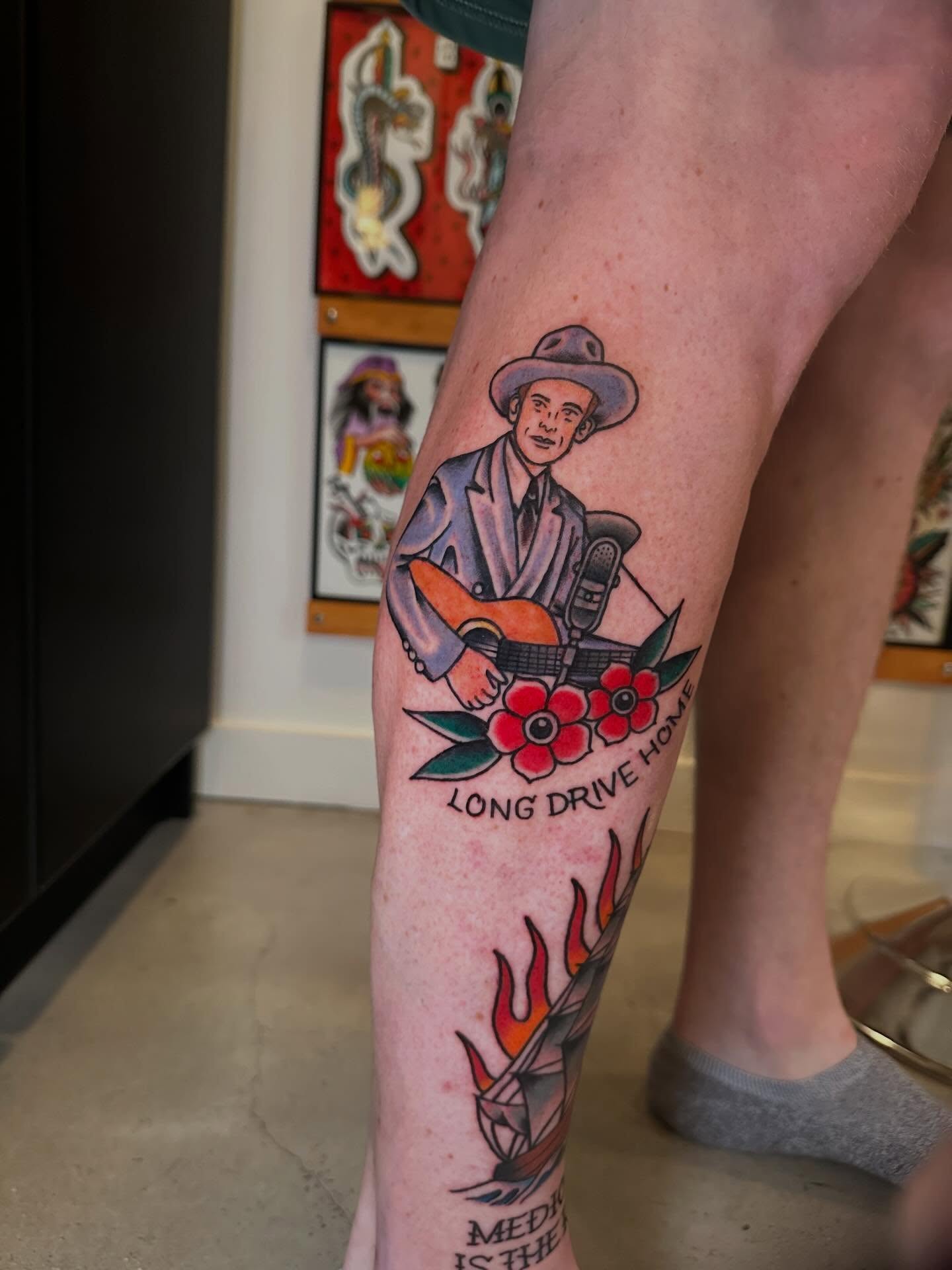 Musician with guitar American traditional tattoo on the leg by Whitney Creep Tattoos
