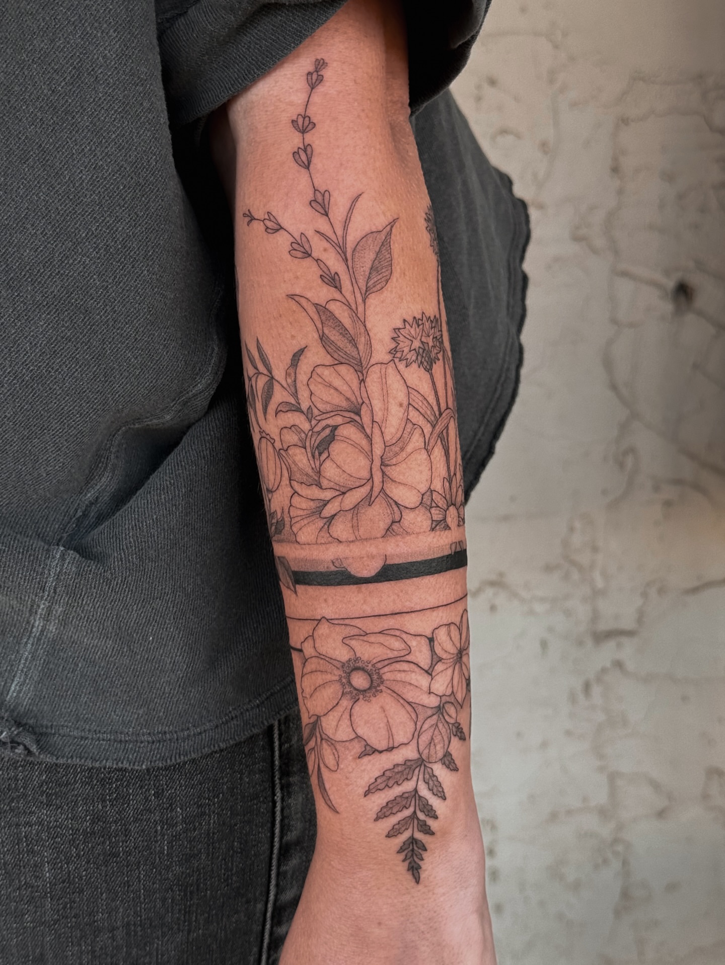 Floral arrangement realism tattoo on the forearm by Floral