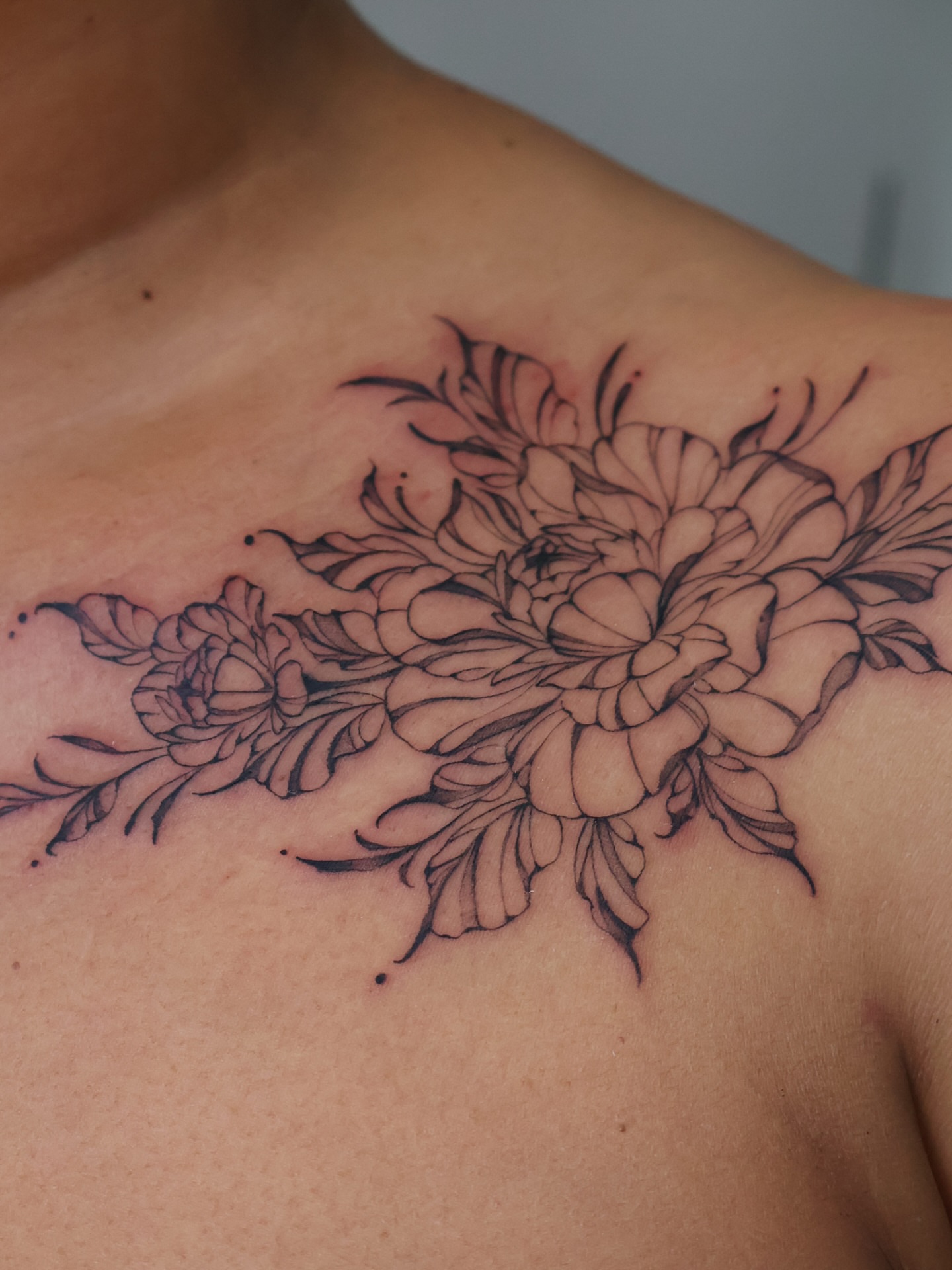 Floral bouquet black and grey tattoo on the chest by Grace Zarmina Hessam