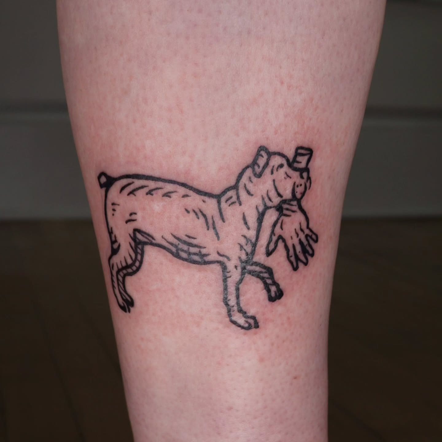 Pig with hat black and grey tattoo on the forearm by Veronika Lipchak