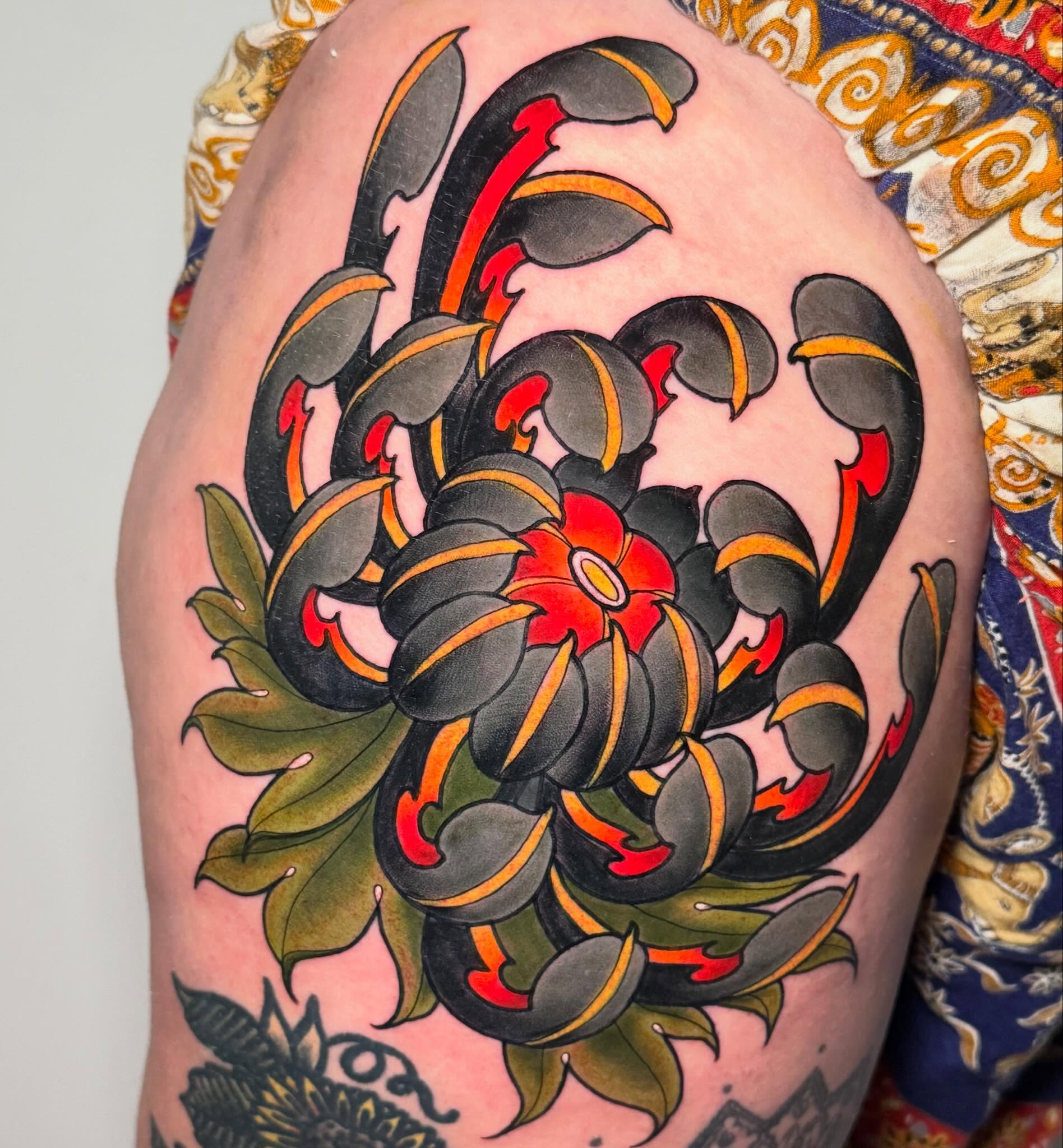 Chrysanthemum American traditional tattoo on the thigh by Kayla Warren