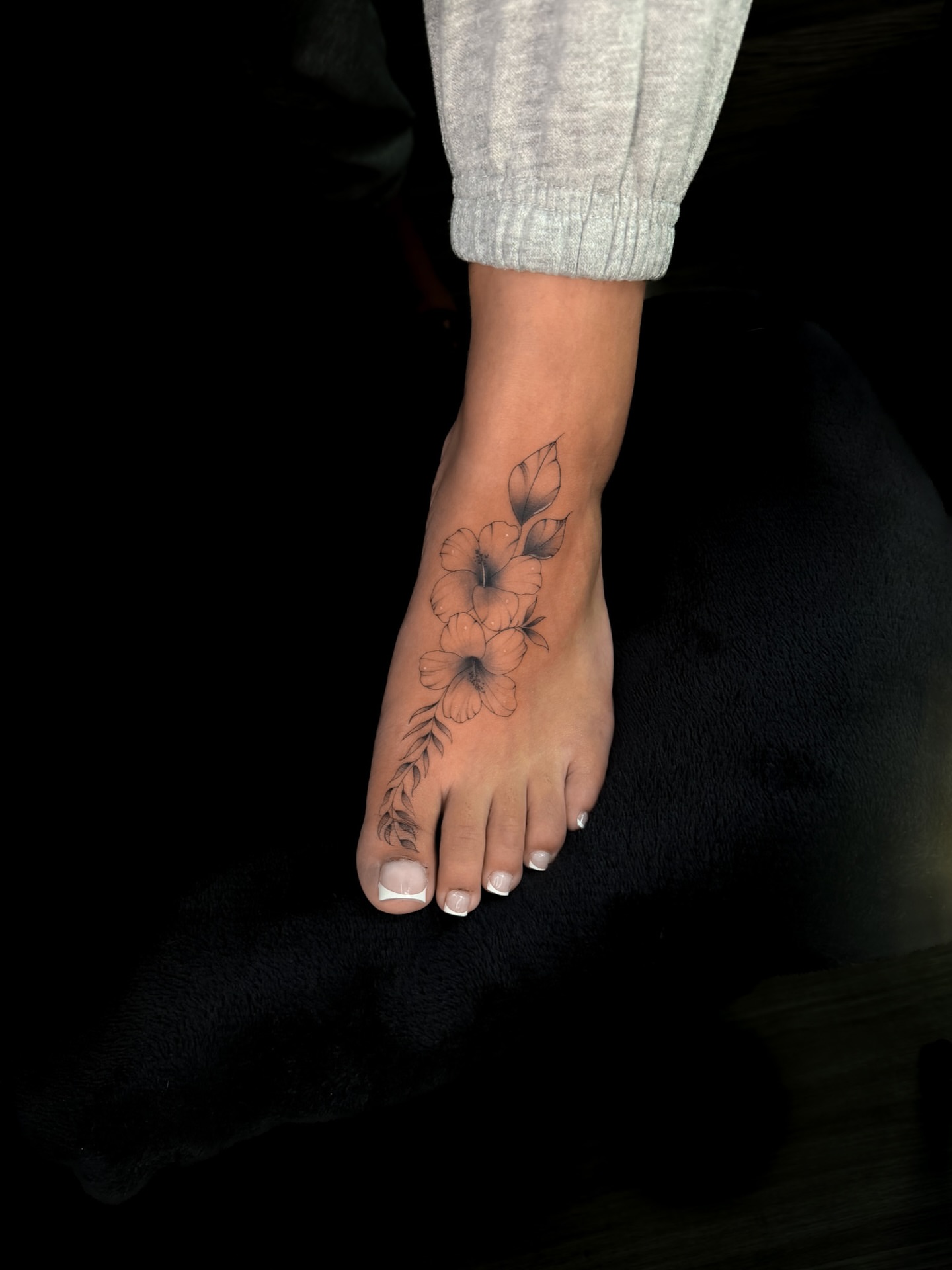 Flower black and grey tattoo on the foot by Elijah Cosme, Miami, Florida