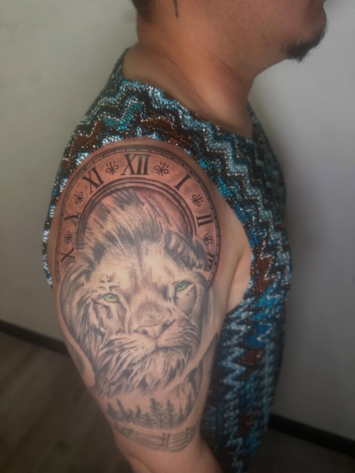 Lion realism tattoo on the upper arm by Javierr Jimenezz