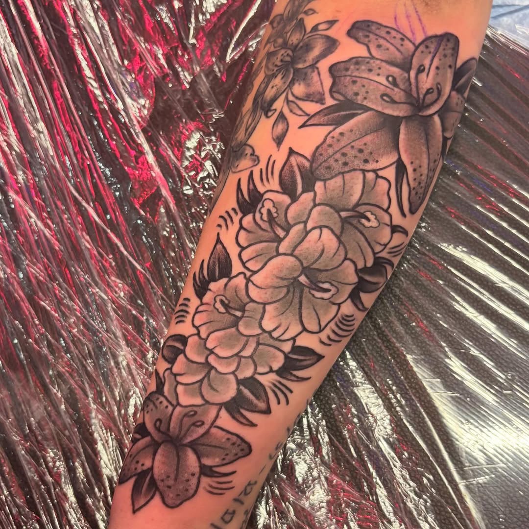 Floral arrangement fine line tattoo on the forearm by @dannydoestattoos