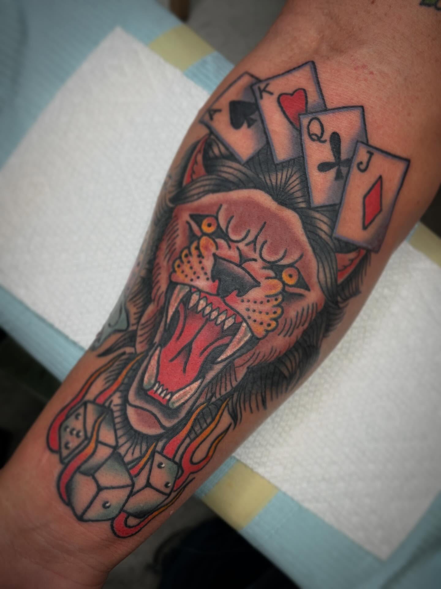 Playing cards and monster American traditional tattoo on the forearm by Drew McElveney, Austin, Texas