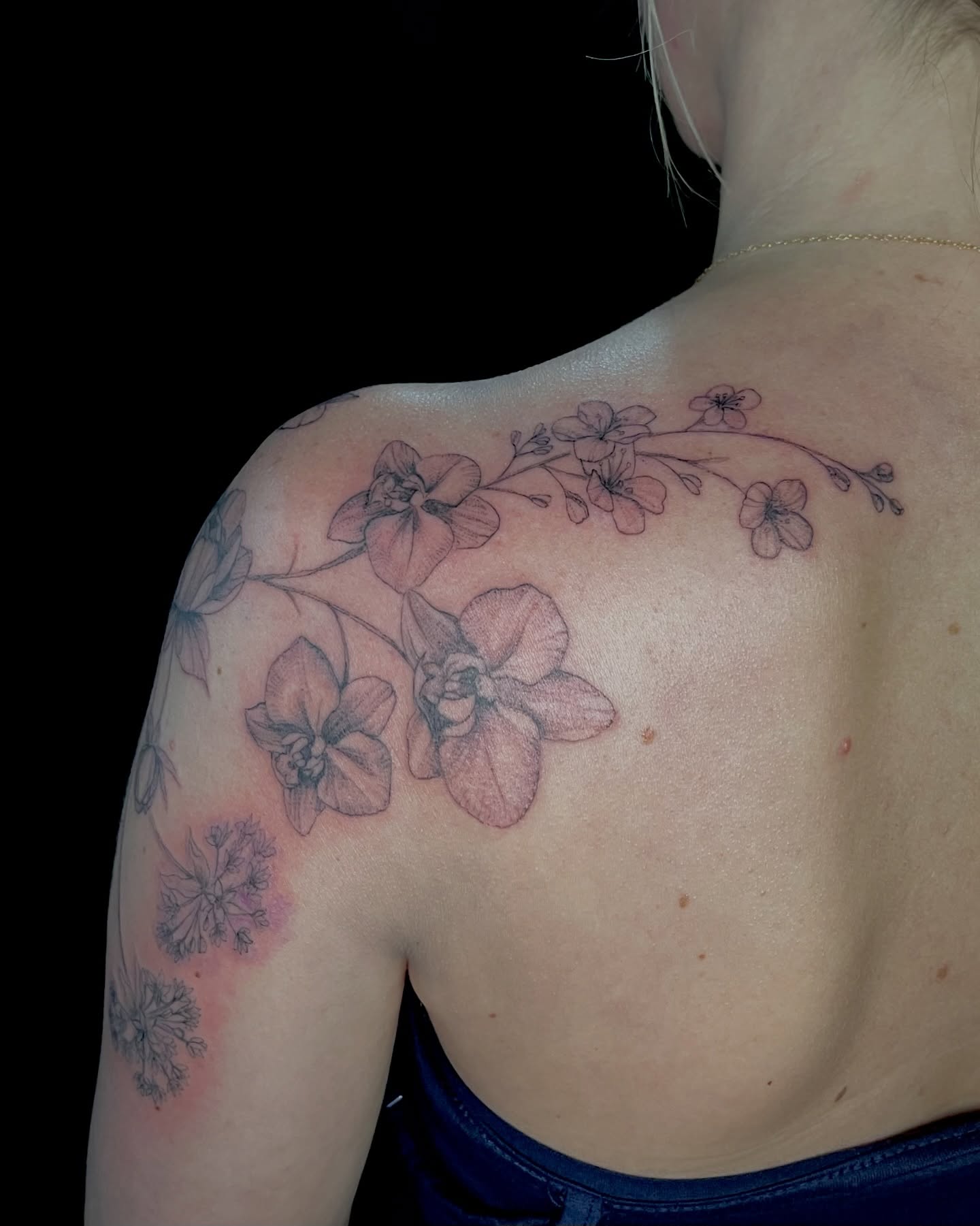 Orchids black and grey tattoo on the shoulder by EO, Chicago, Illinois