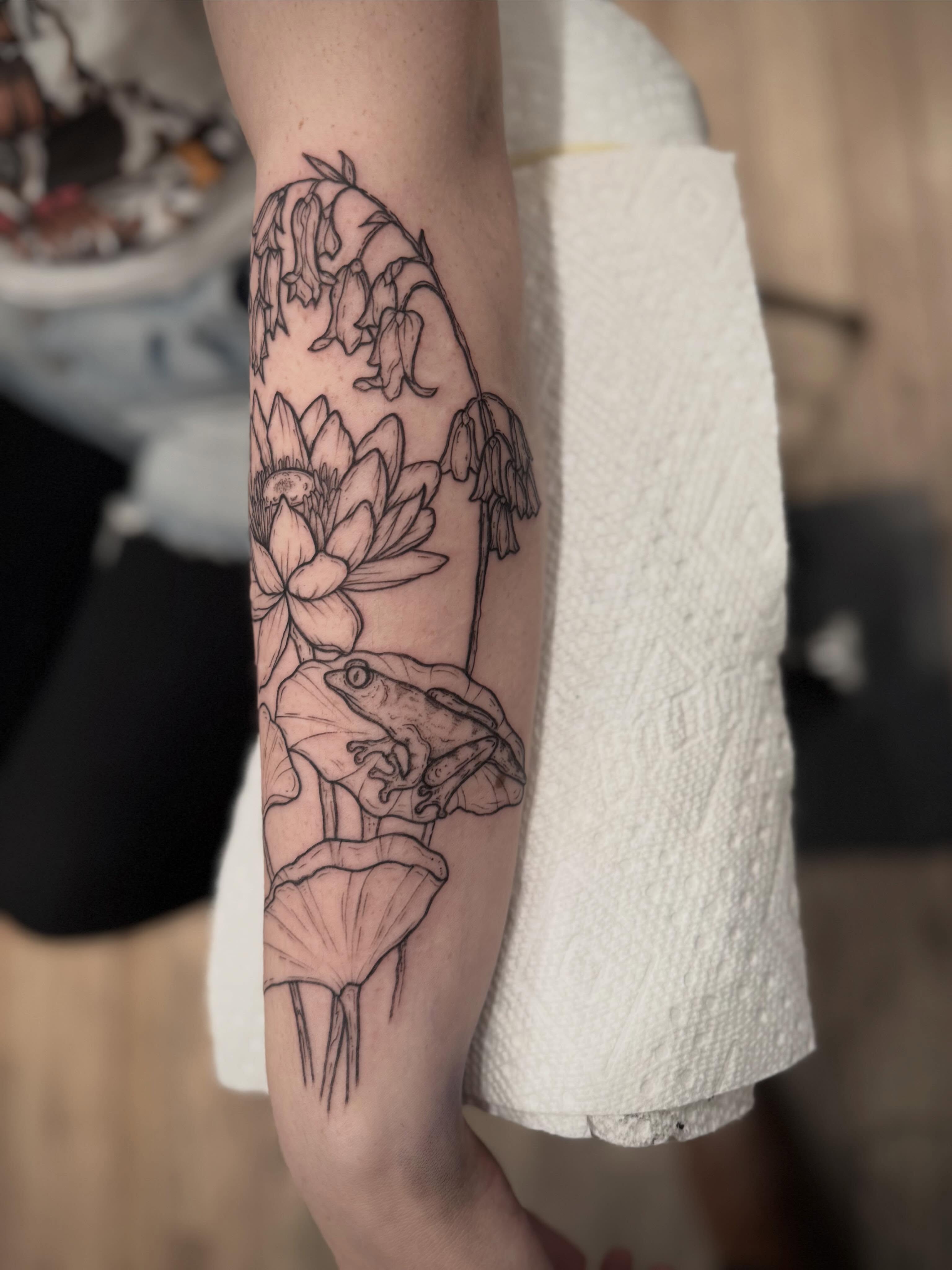 Frog and lotus black and grey tattoo on the forearm by Daniel Anthony, Philadelphia, Pennsylvania