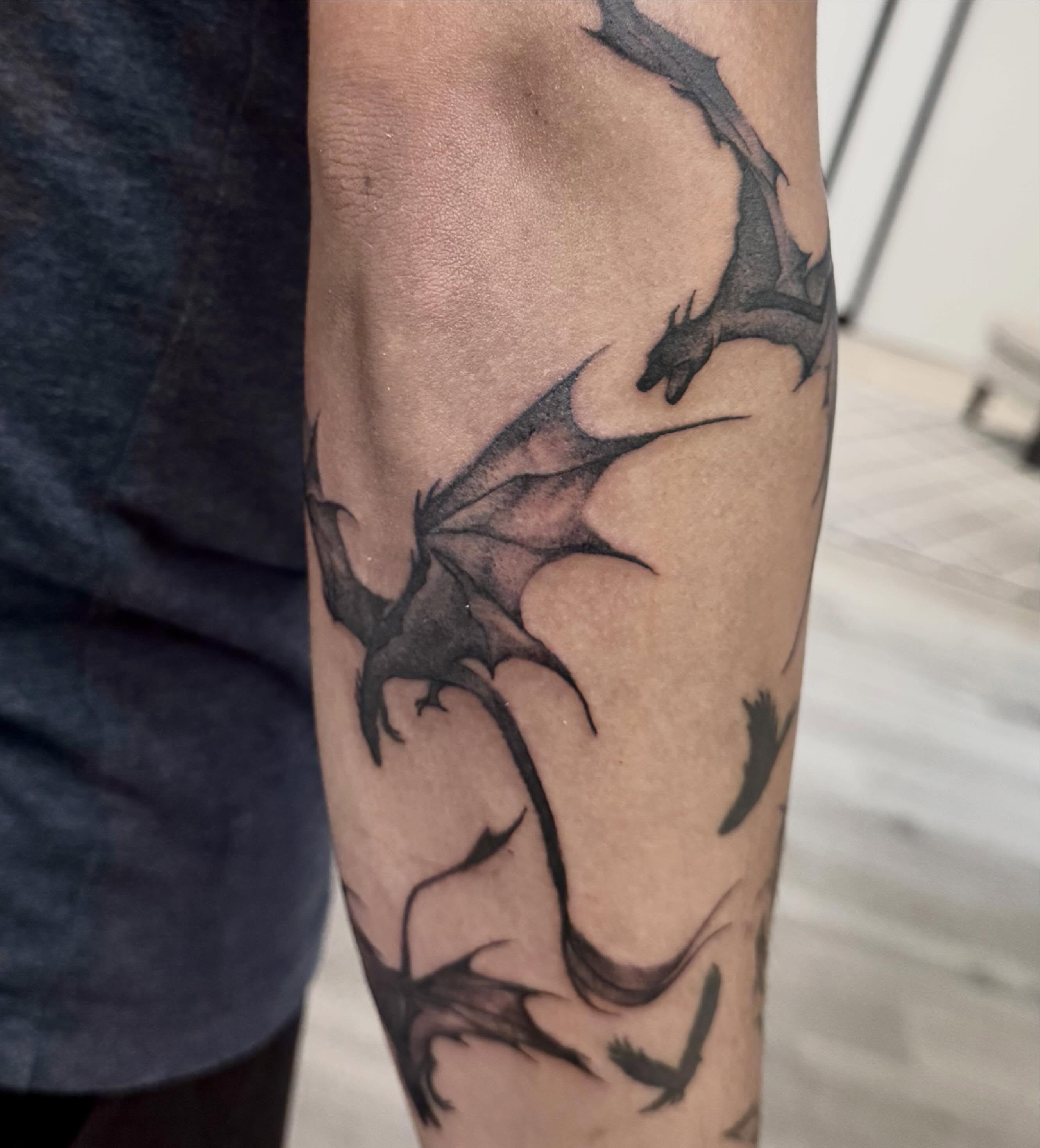 Dragon black and grey tattoo on the forearm by Gigi