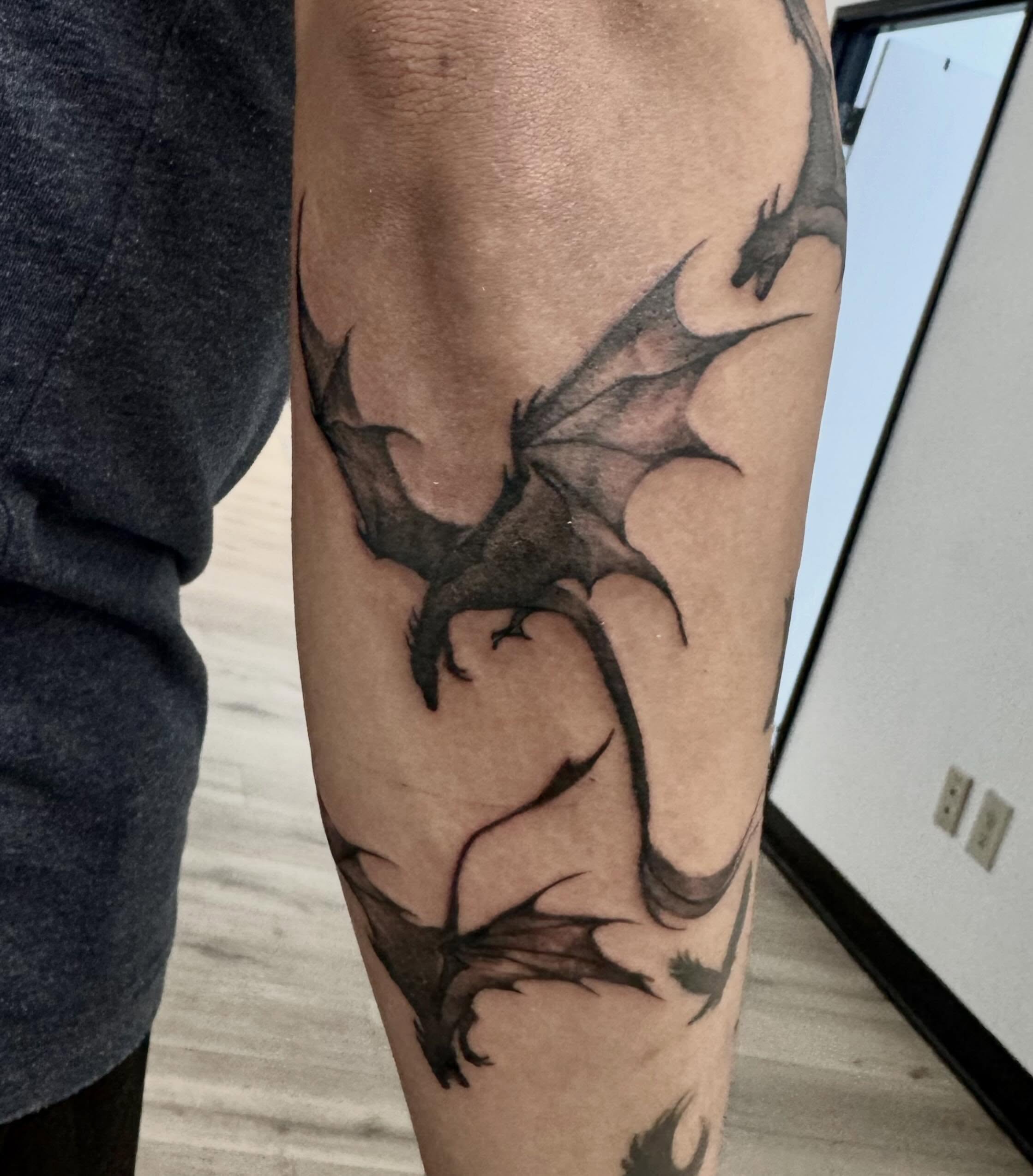 Dragon black and grey tattoo on the forearm by Gigi