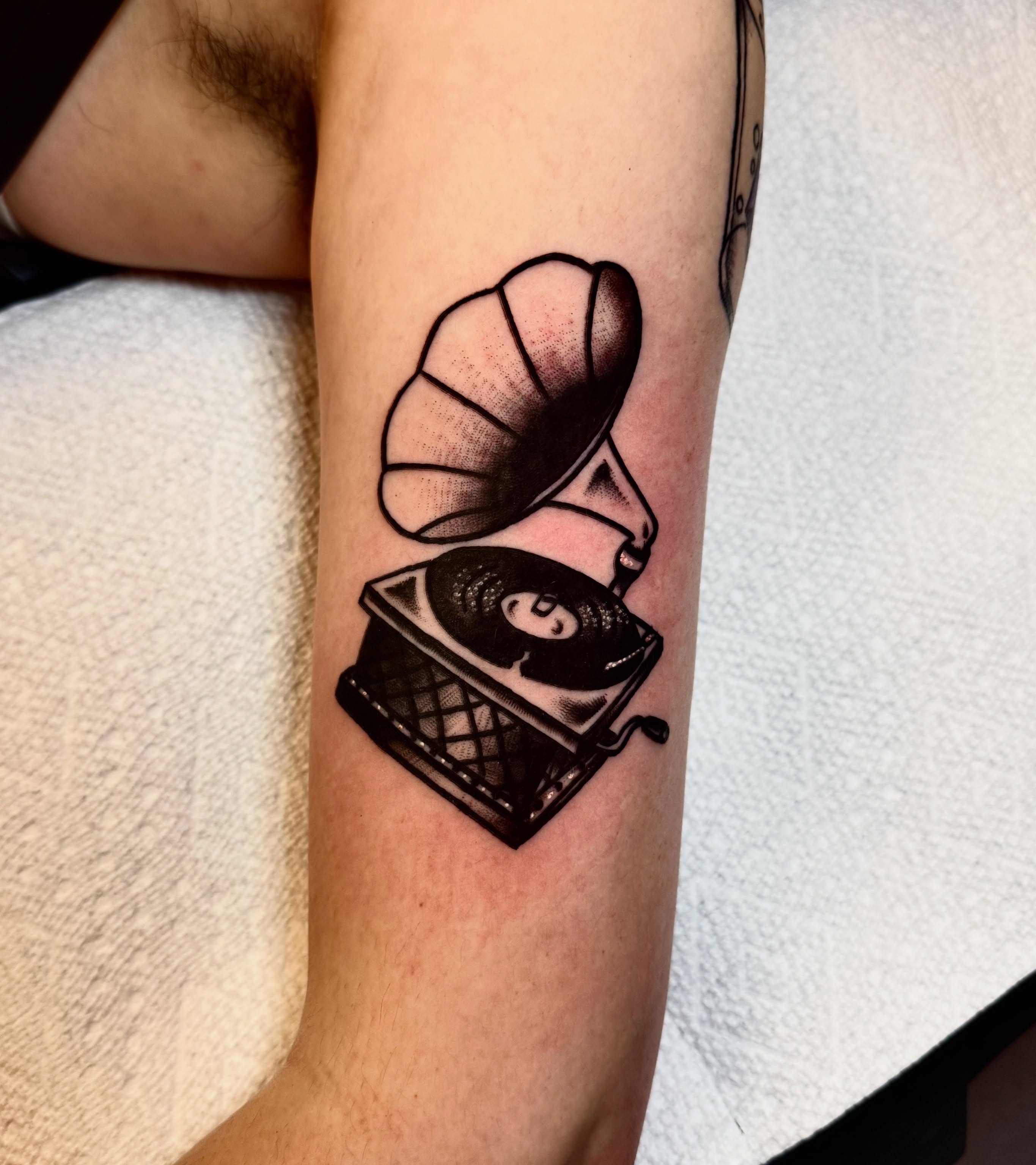 Gramophone black and grey tattoo on the forearm by Brandon