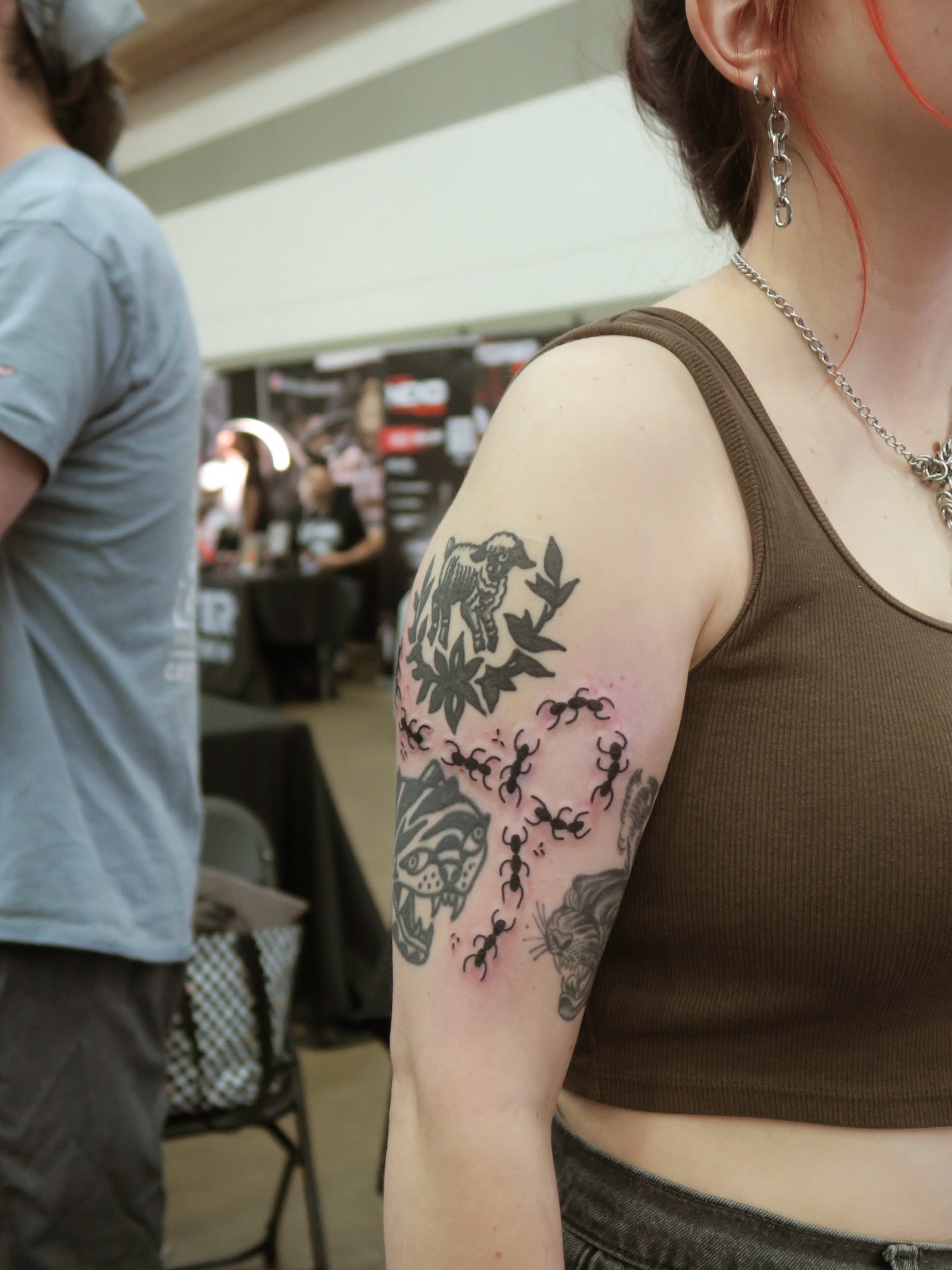 Bull and floral black and grey tattoo on the upper arm by Roman