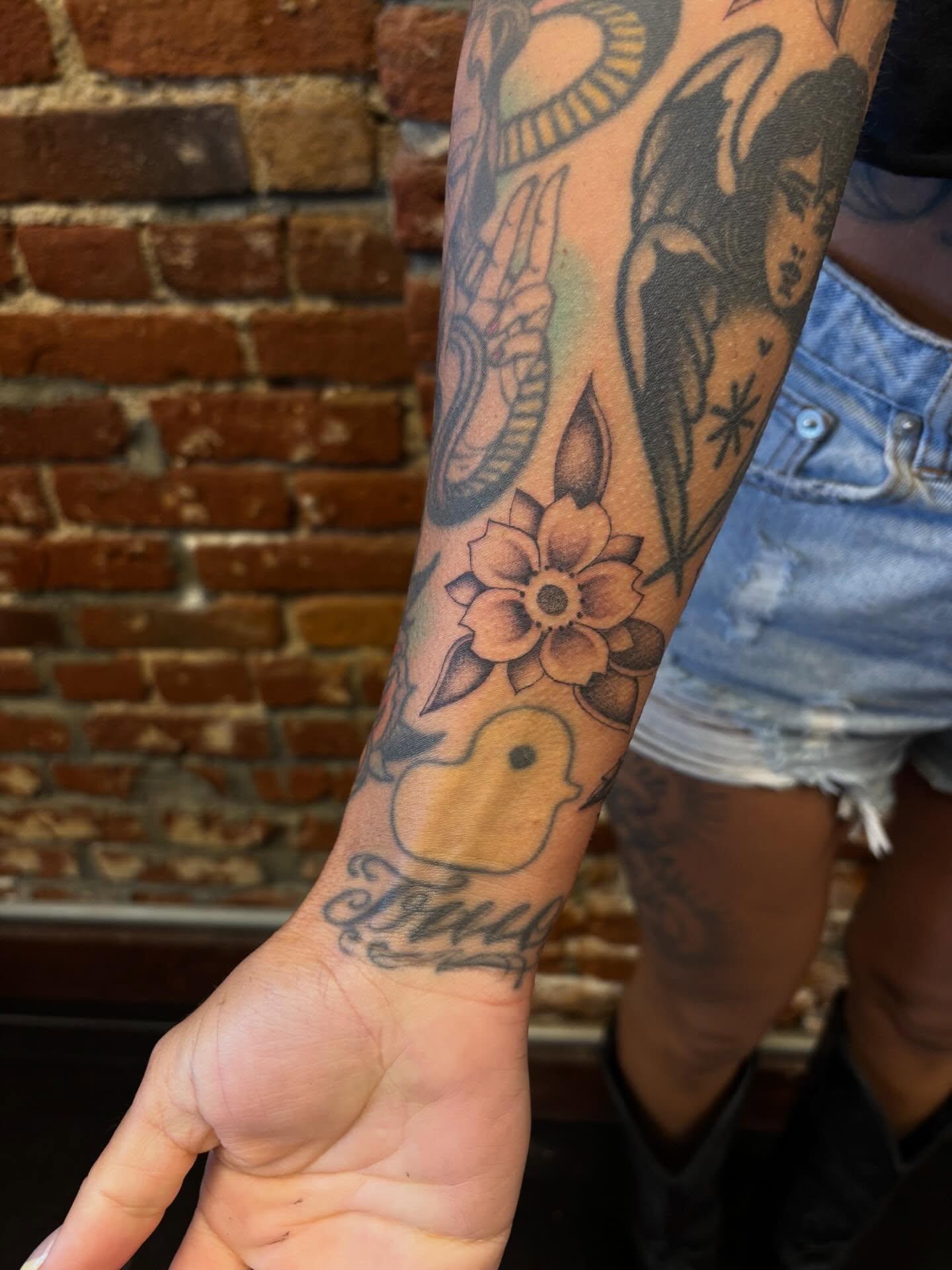 Flower and bird American traditional tattoo on the forearm by Alyssa L'Heureux🕴🏼, Los Angeles, California