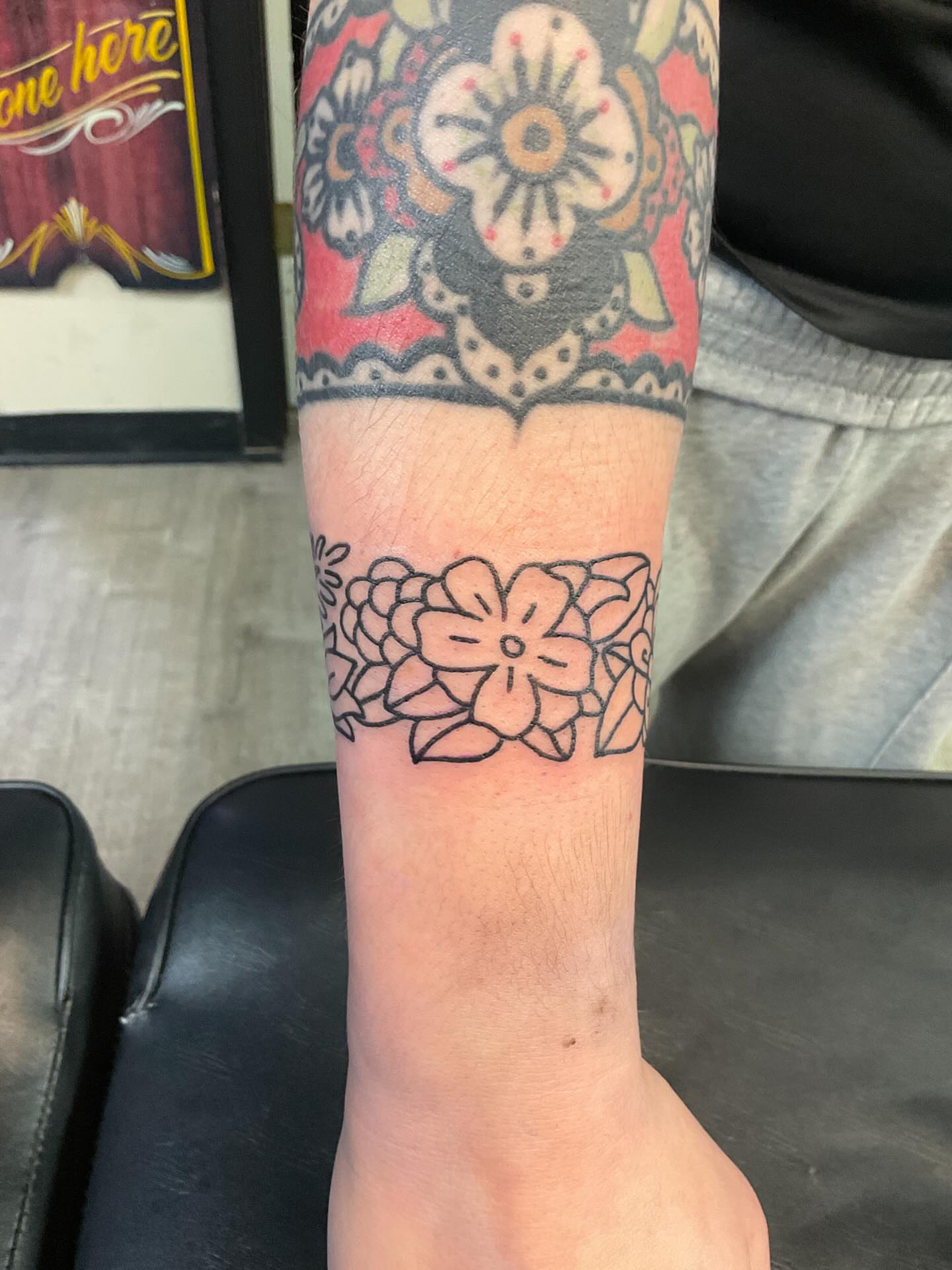 Floral design black and grey tattoo on the forearm by Mercury
