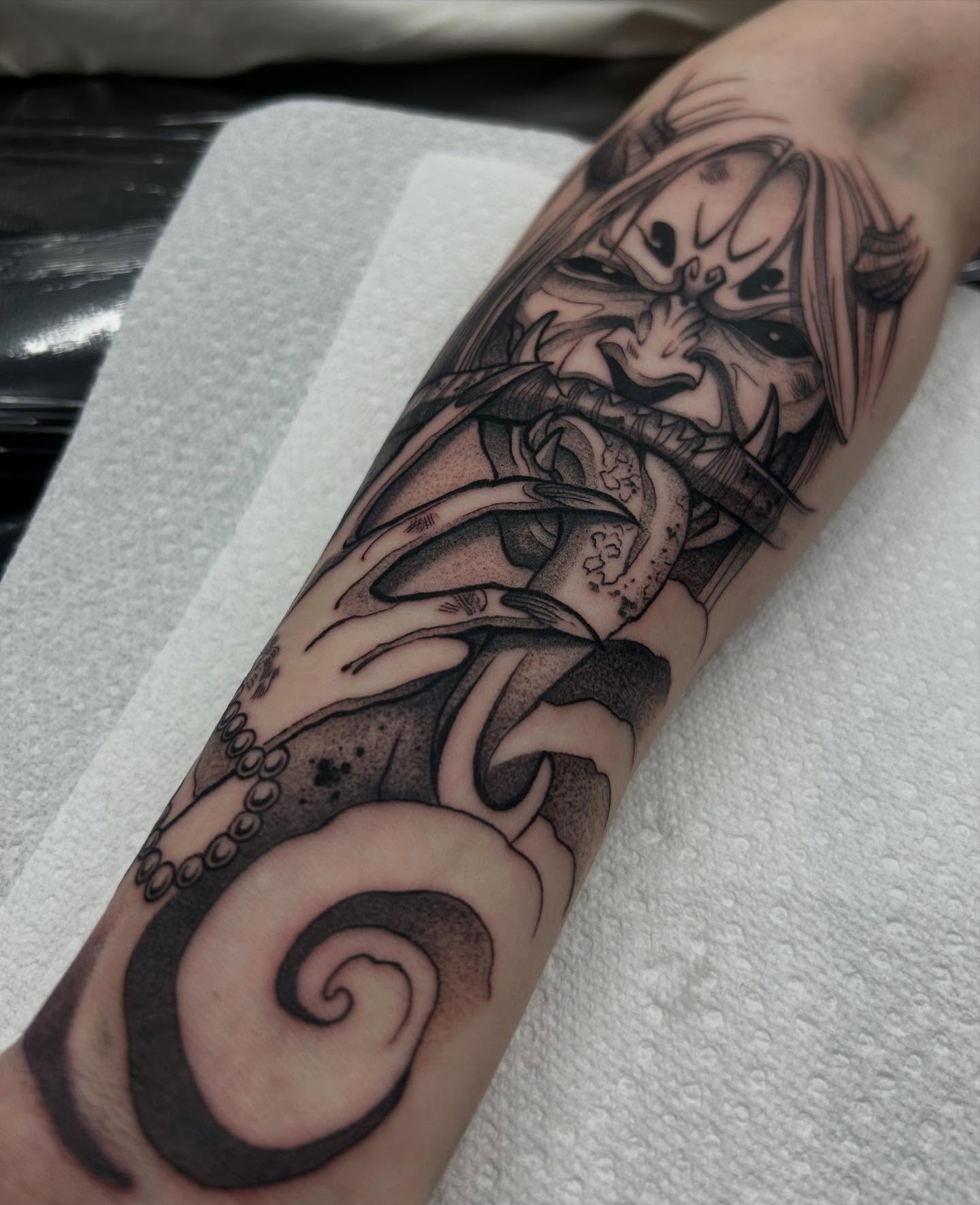 Octopus and clown dark realism tattoo on the forearm by Livy baby