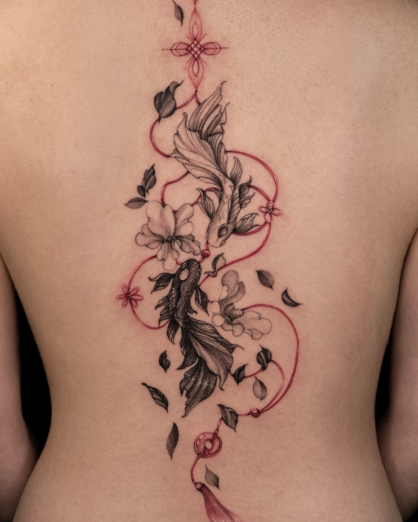 Koi fish and flowers black and grey tattoo on the back by Wong Lee