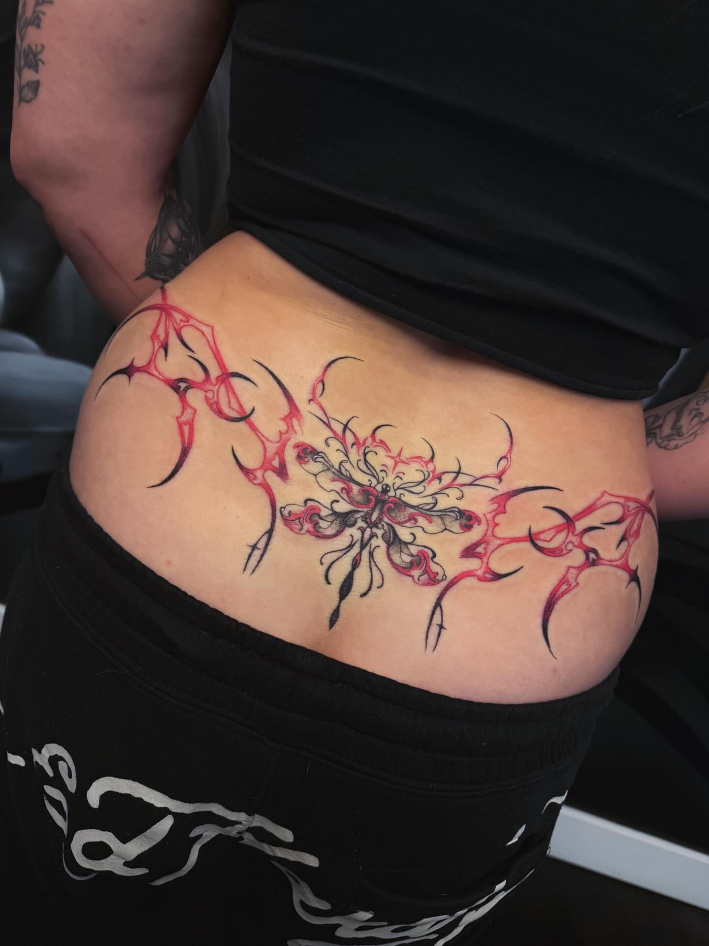 Cross tribal tattoo on the thigh by Yvonne