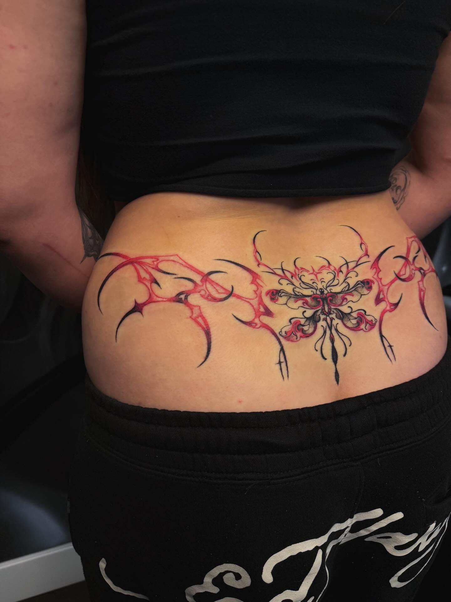 Abstract floral tribal tattoo on the thigh by Yvonne