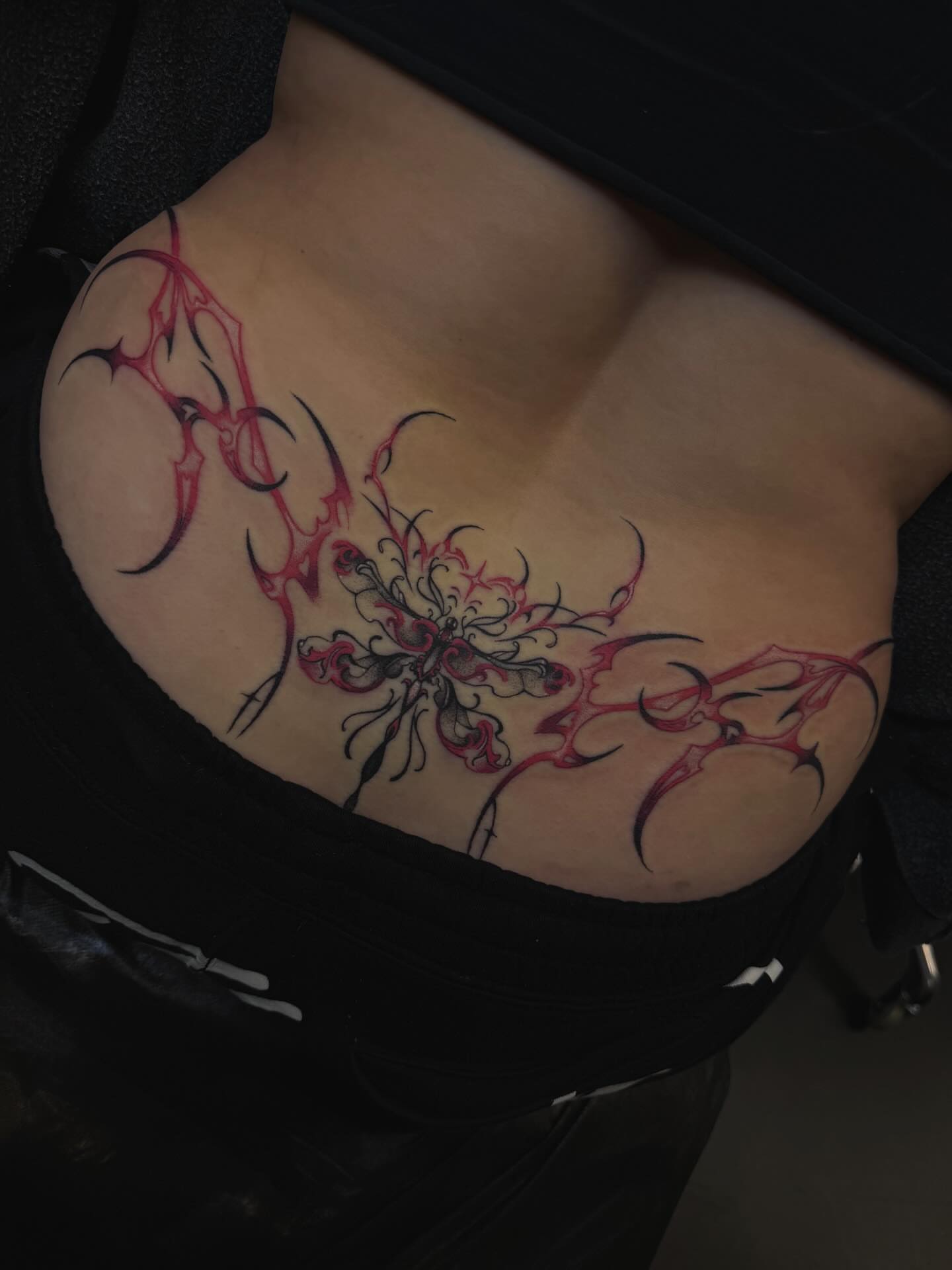 Abstract floral tribal tattoo on the torso by Yvonne