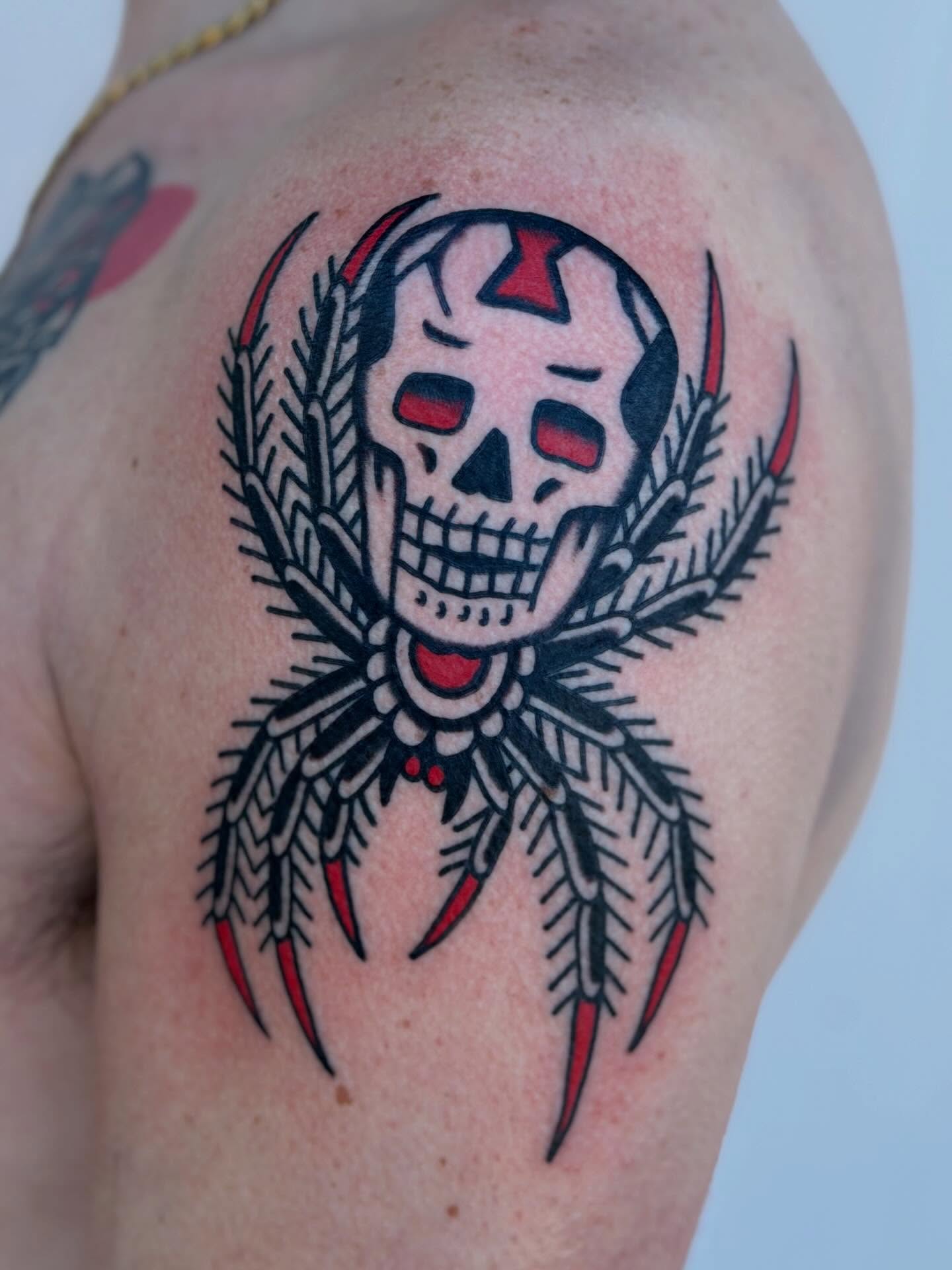 Skull with laurel wreath American traditional tattoo on the shoulder by Blake Francis, Worcester, Massachusetts