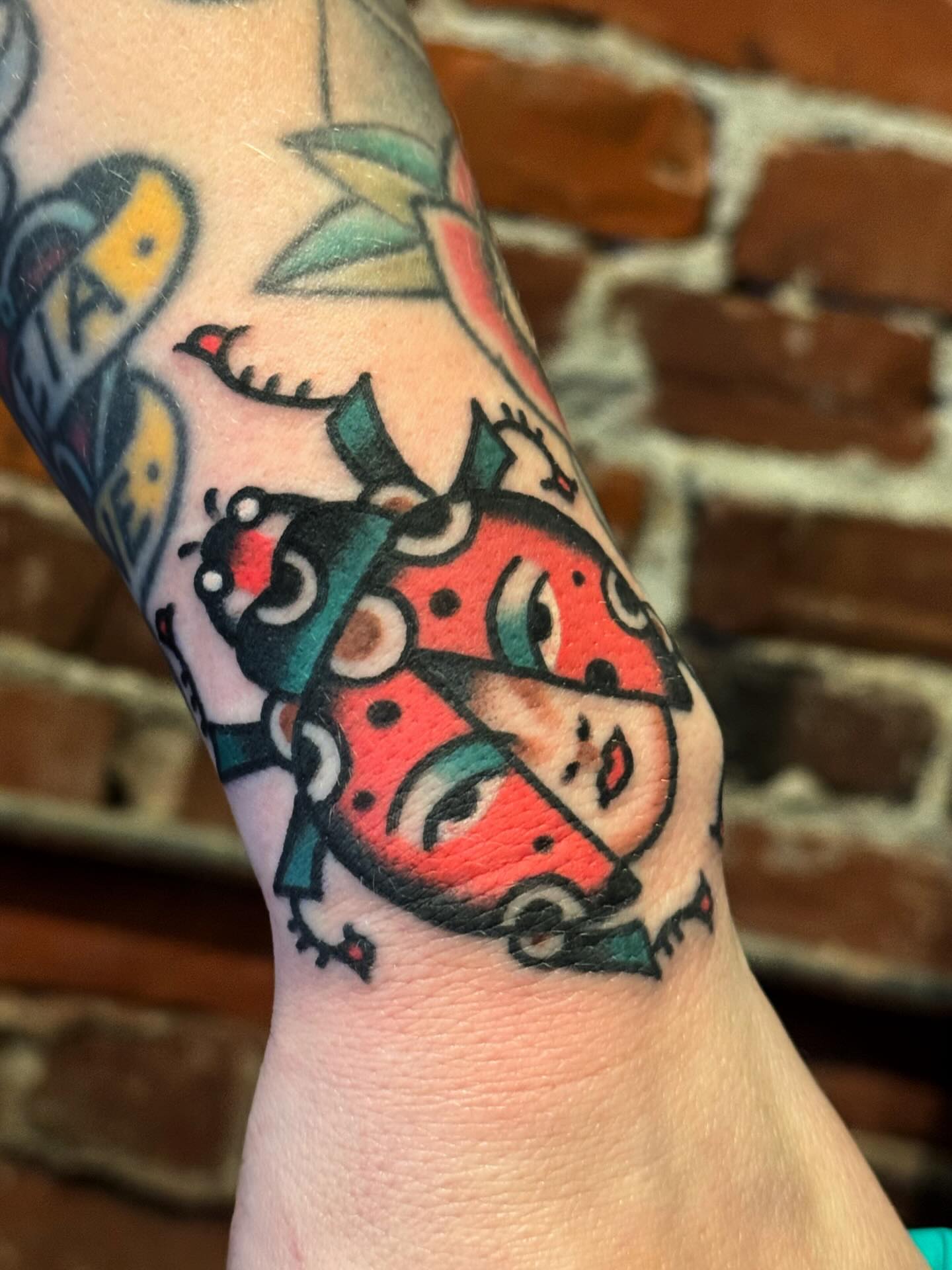 Ladybug American traditional tattoo on the forearm by Bryce Shearer