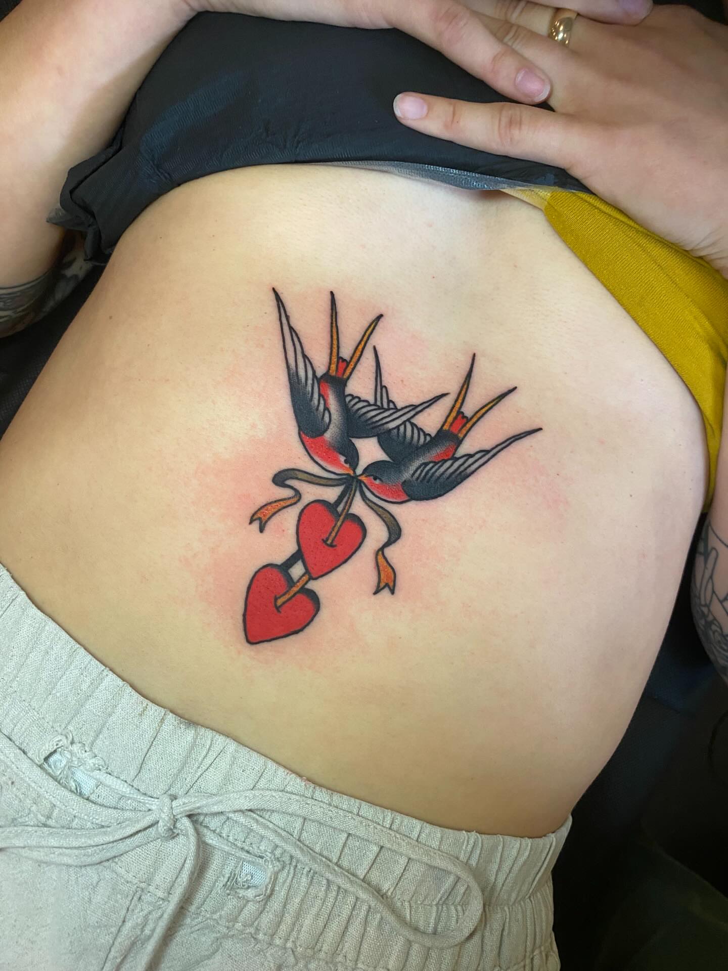 Swallows and heart American traditional tattoo on the back by Jaclin Grace Hastings