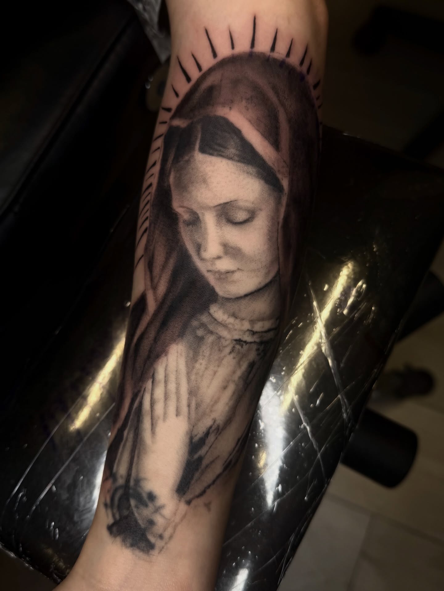 Religious figure praying realism tattoo on the forearm by Jennifer Contreras